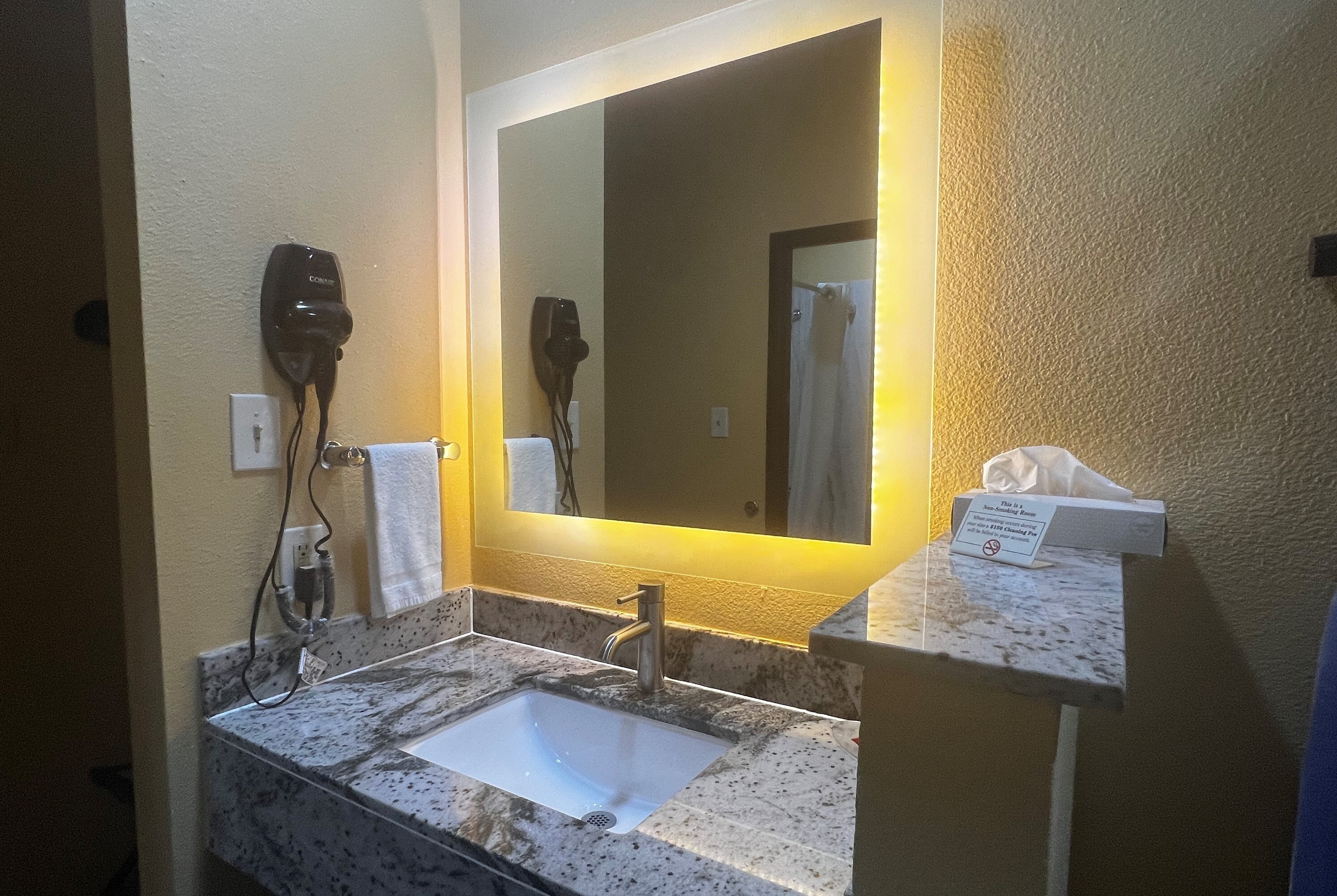 Guest room bath at the Super 8 by Wyndham Pasadena in Pasadena, Texas