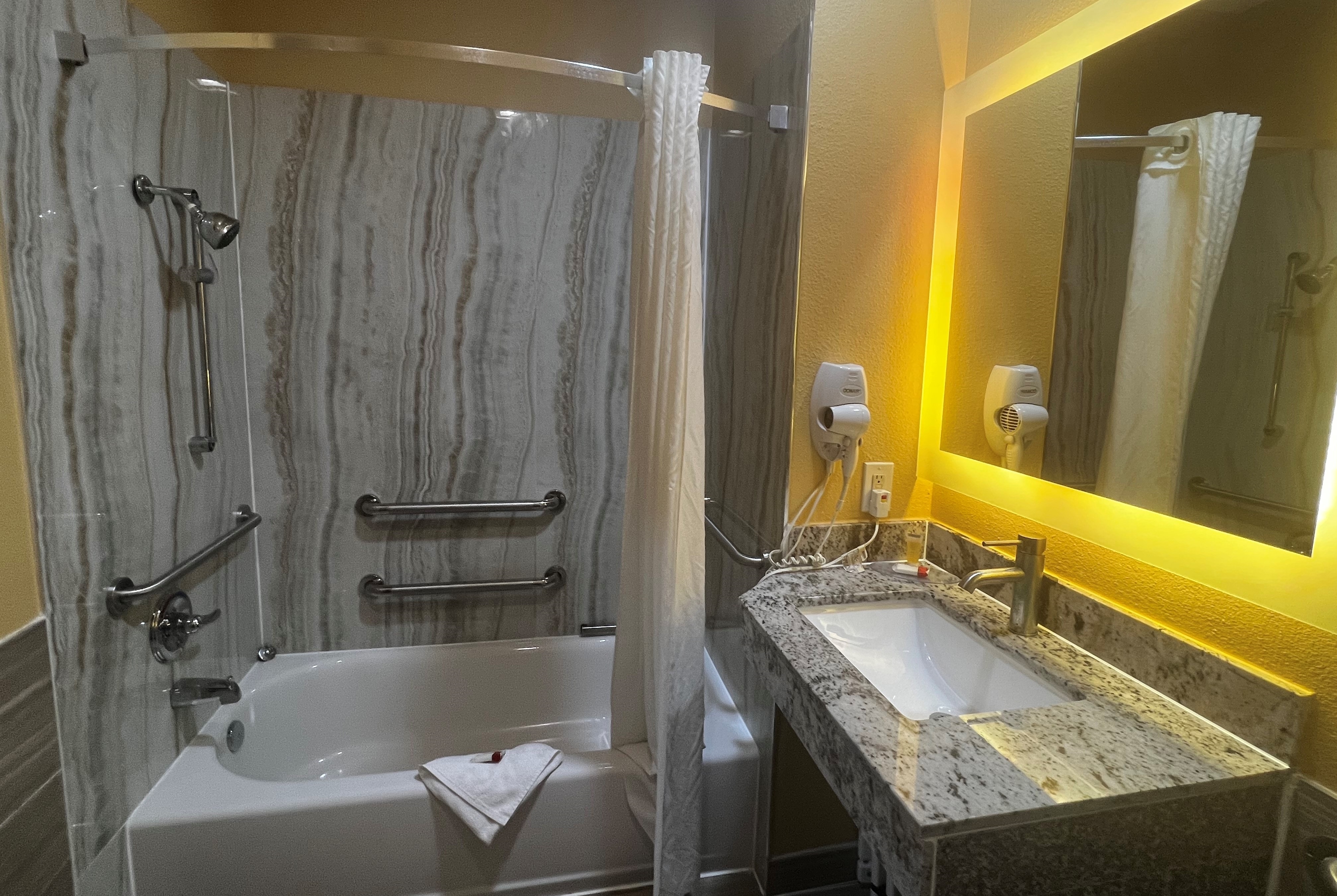 Guest room bath at the Super 8 by Wyndham Pasadena in Pasadena, Texas