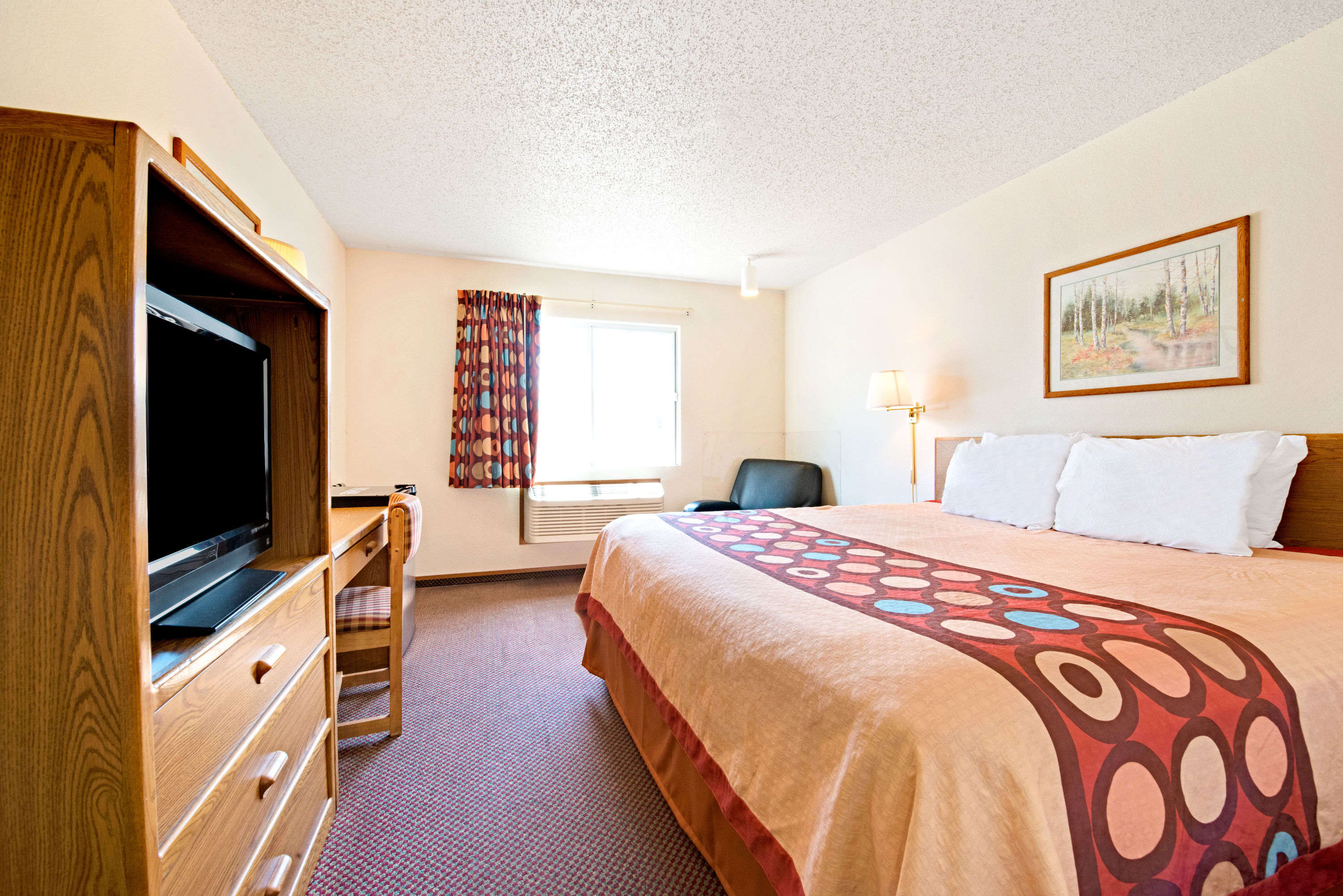 Guest room at the Super 8 by Wyndham Plano/Dallas Area in Plano, Texas
