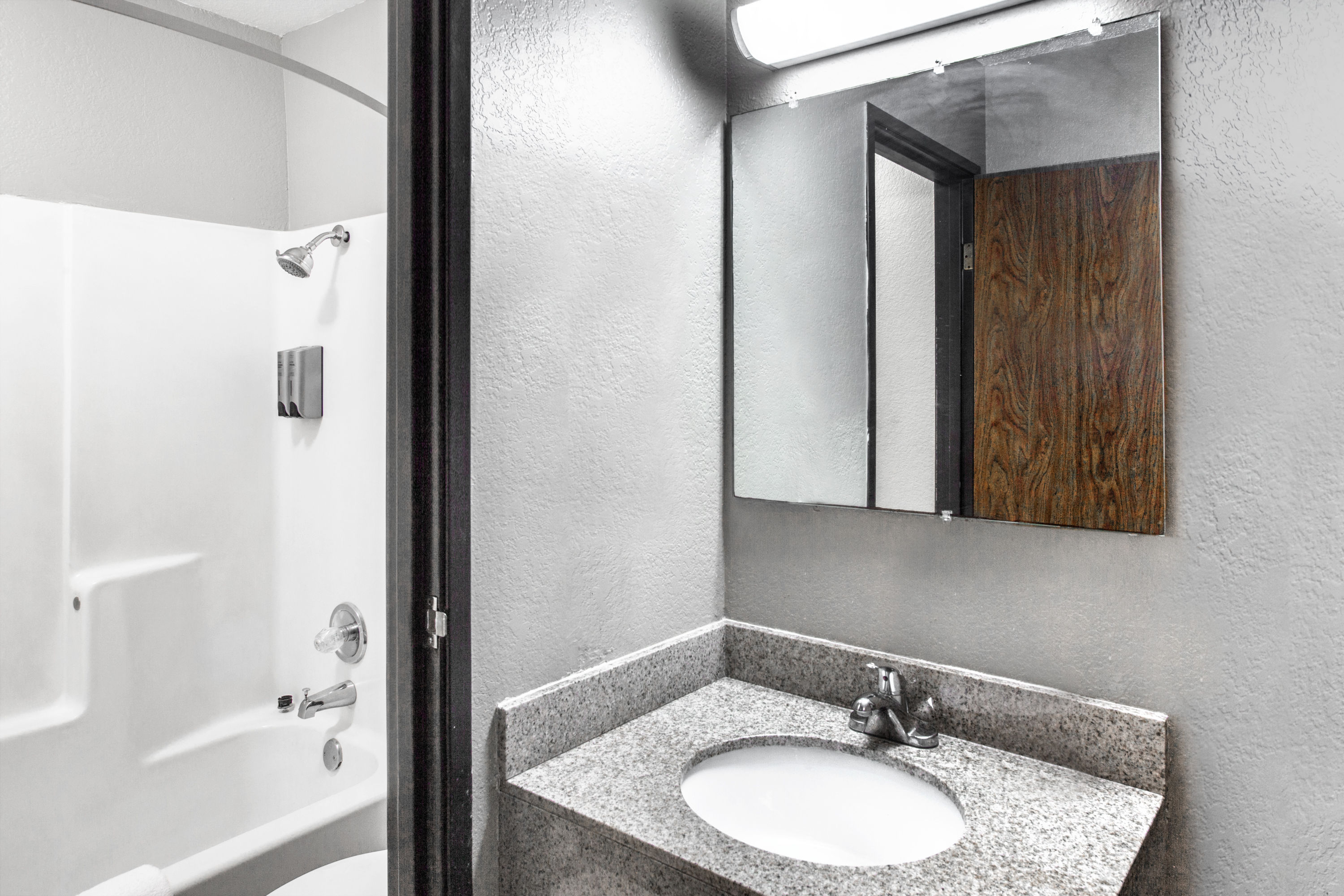 Guest room bath at the Super 8 by Wyndham Sherman in Sherman, Texas