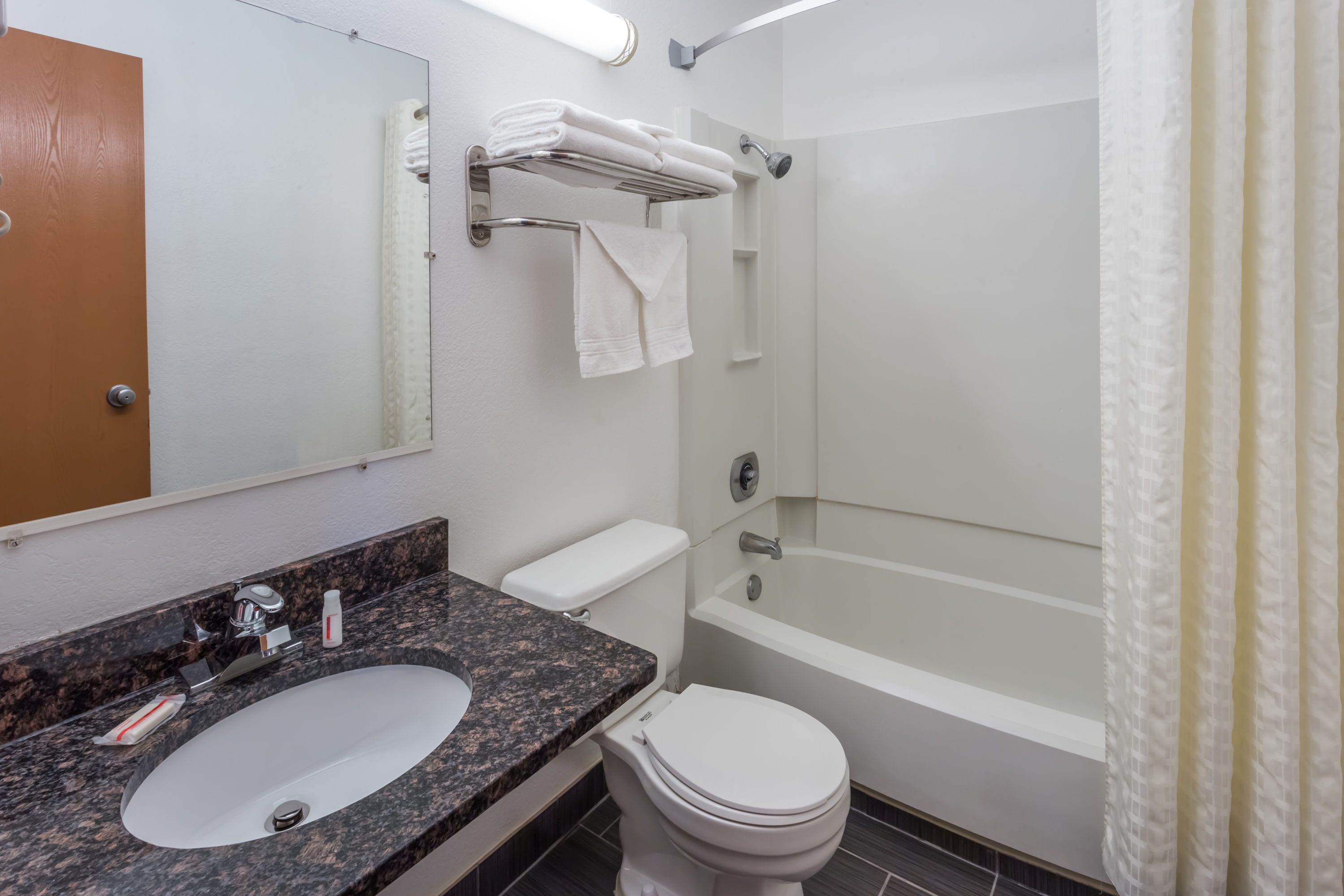 Guest room bath at the Super 8 by Wyndham Janesville in Janesville, Wisconsin