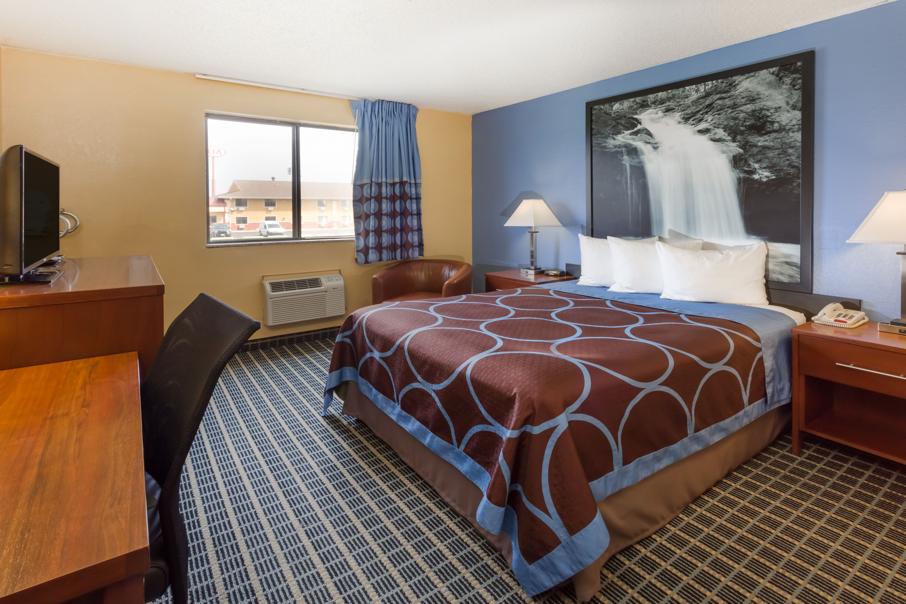 Guest room at the Super 8 by Wyndham Janesville in Janesville, Wisconsin
