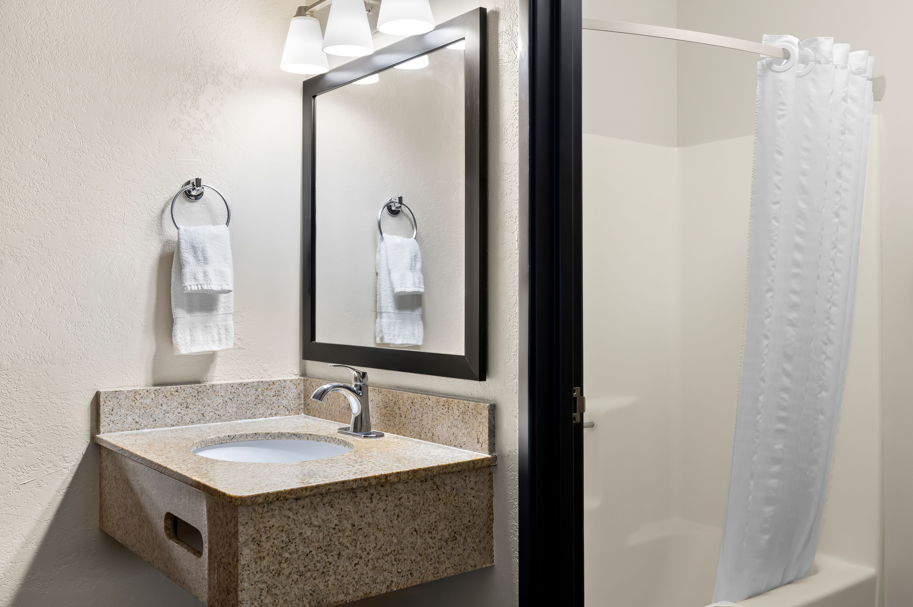 Guest room bath at the Super 8 by Wyndham La Crosse in La Crosse, Wisconsin