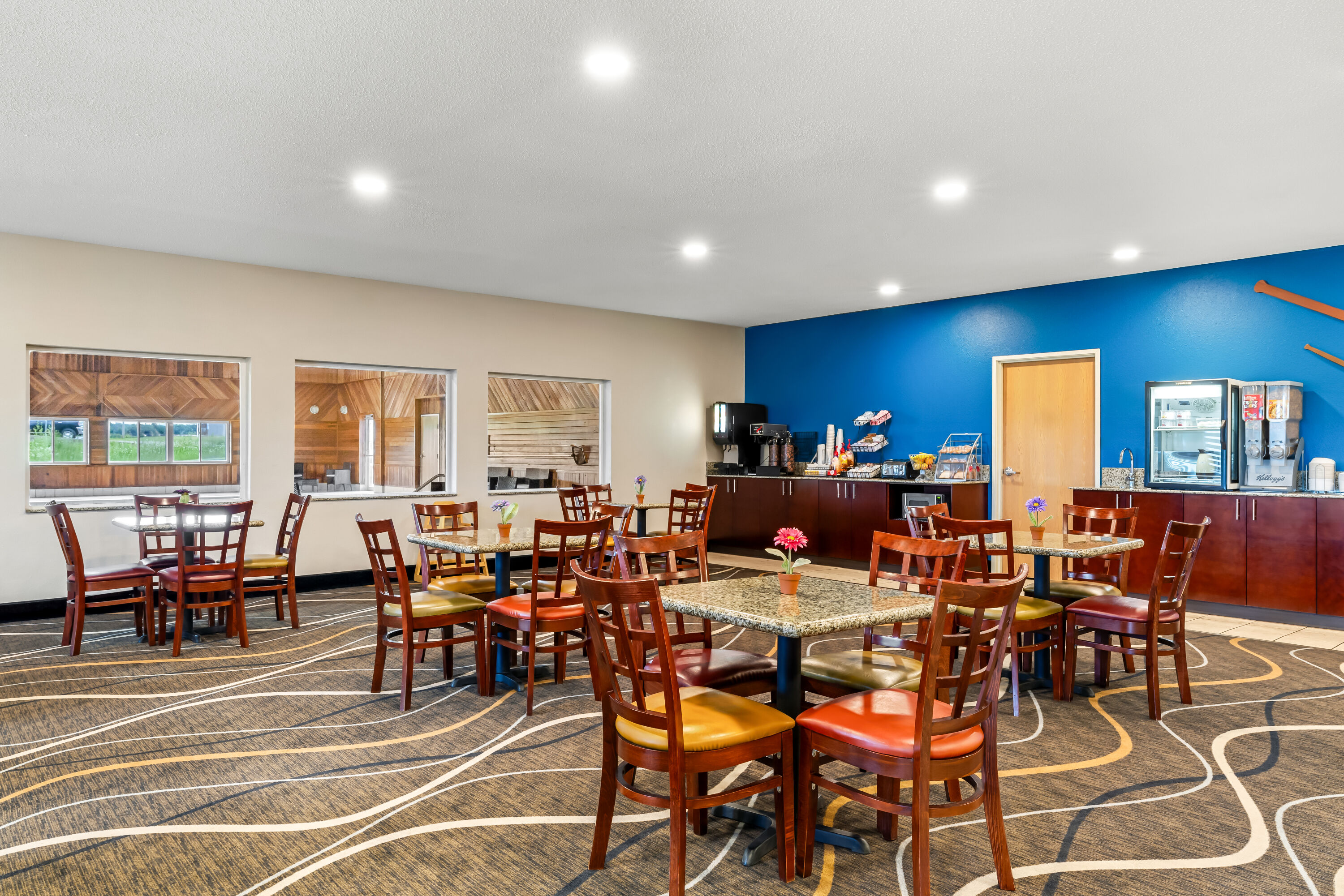 Super 8 by Wyndham Osseo WI restaurant breakfast area with seating in Osseo, Wisconsin