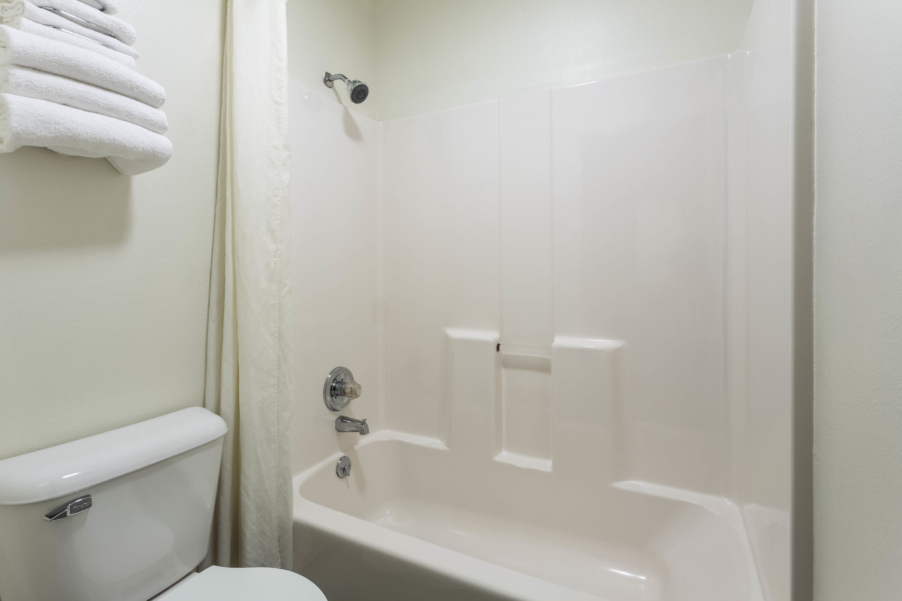 Guest room bath at the Super 8 by Wyndham Reedsburg in Reedsburg, Wisconsin