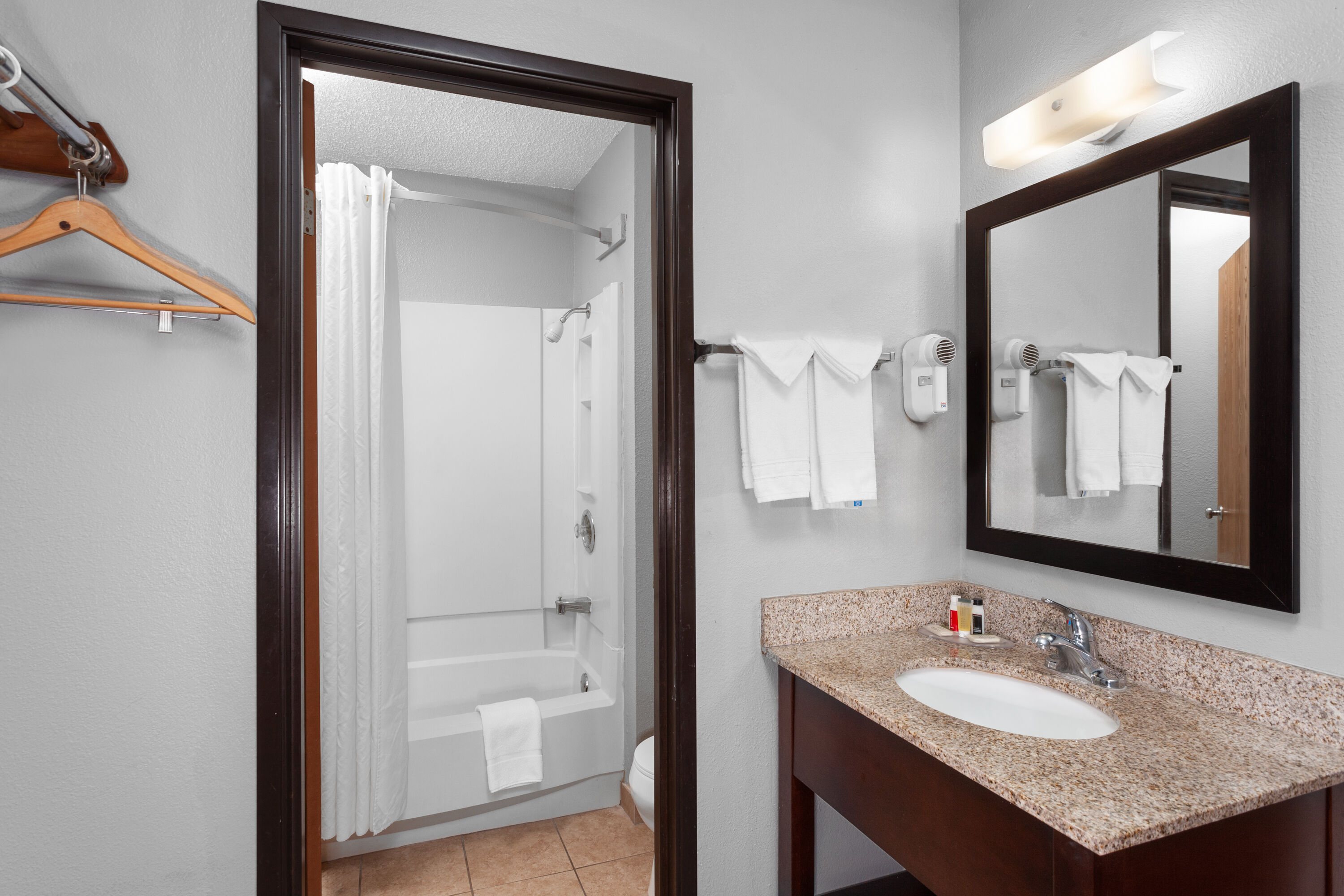 Guest room bath at the Super 8 by Wyndham Sun Prairie/Madison E in Sun Prairie, Wisconsin