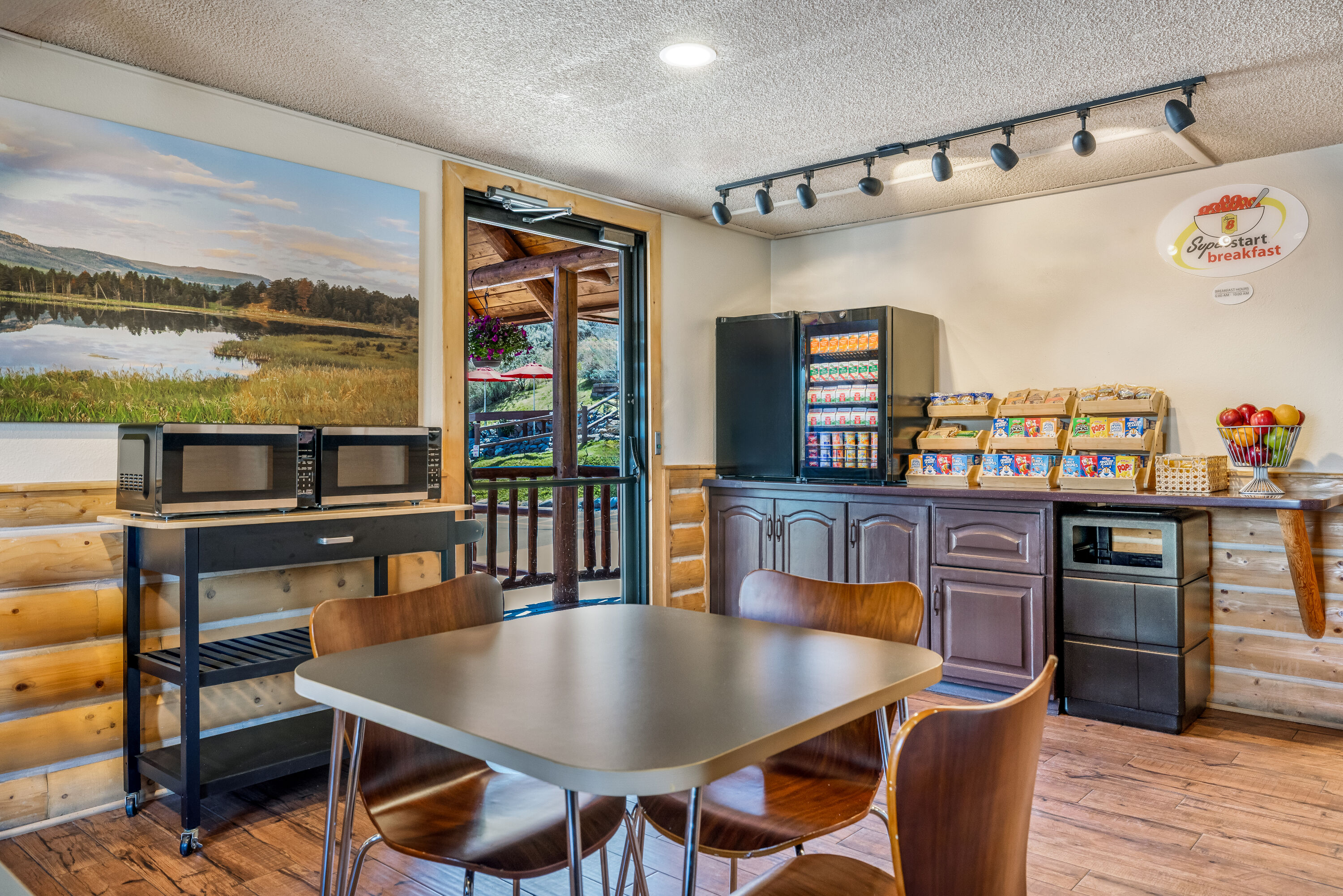 Super 8 by Wyndham Cody restaurant breakfast area with seating in Cody, Wyoming
