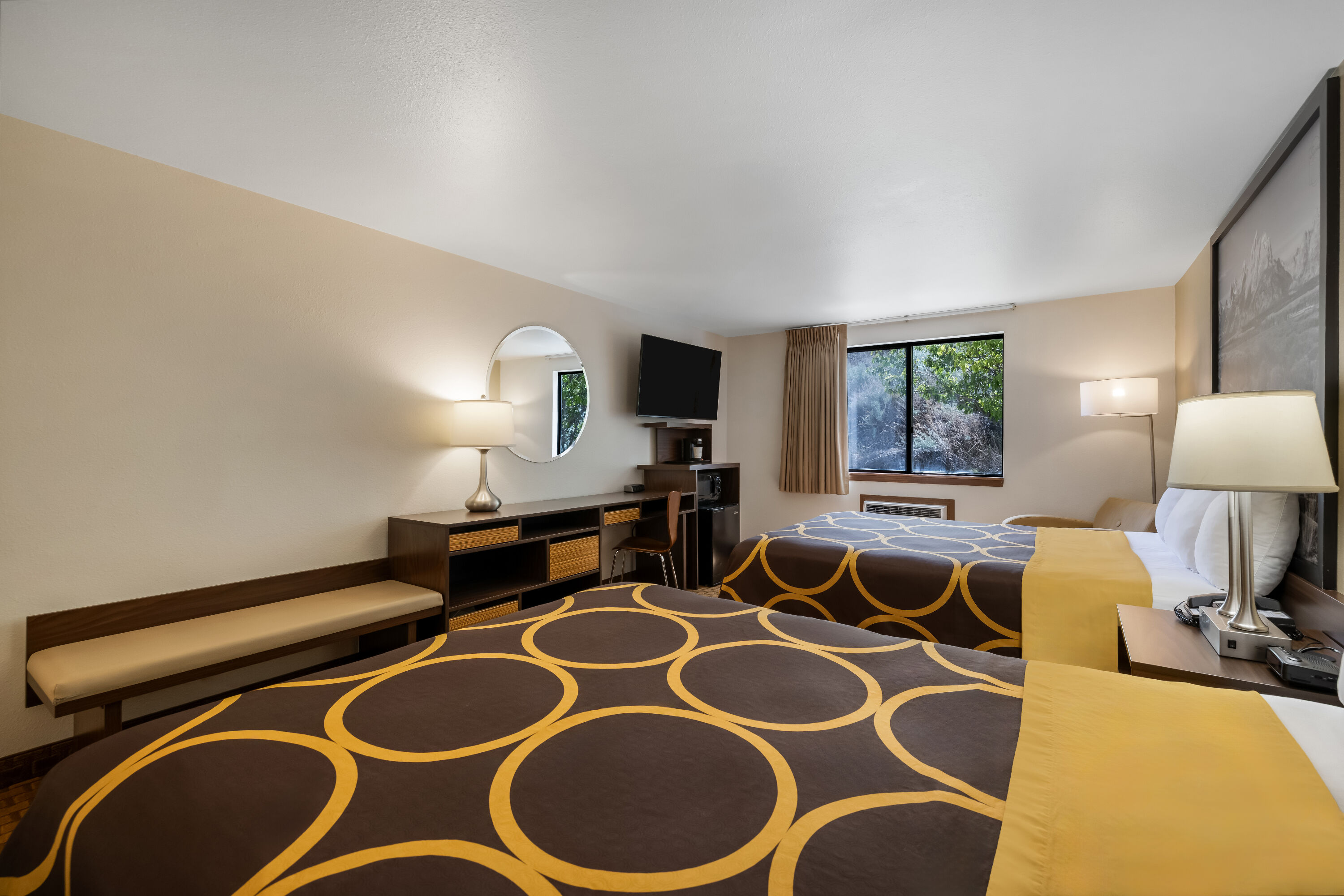 Queen bed guest room at the Super 8 by Wyndham Cody in Cody, Wyoming