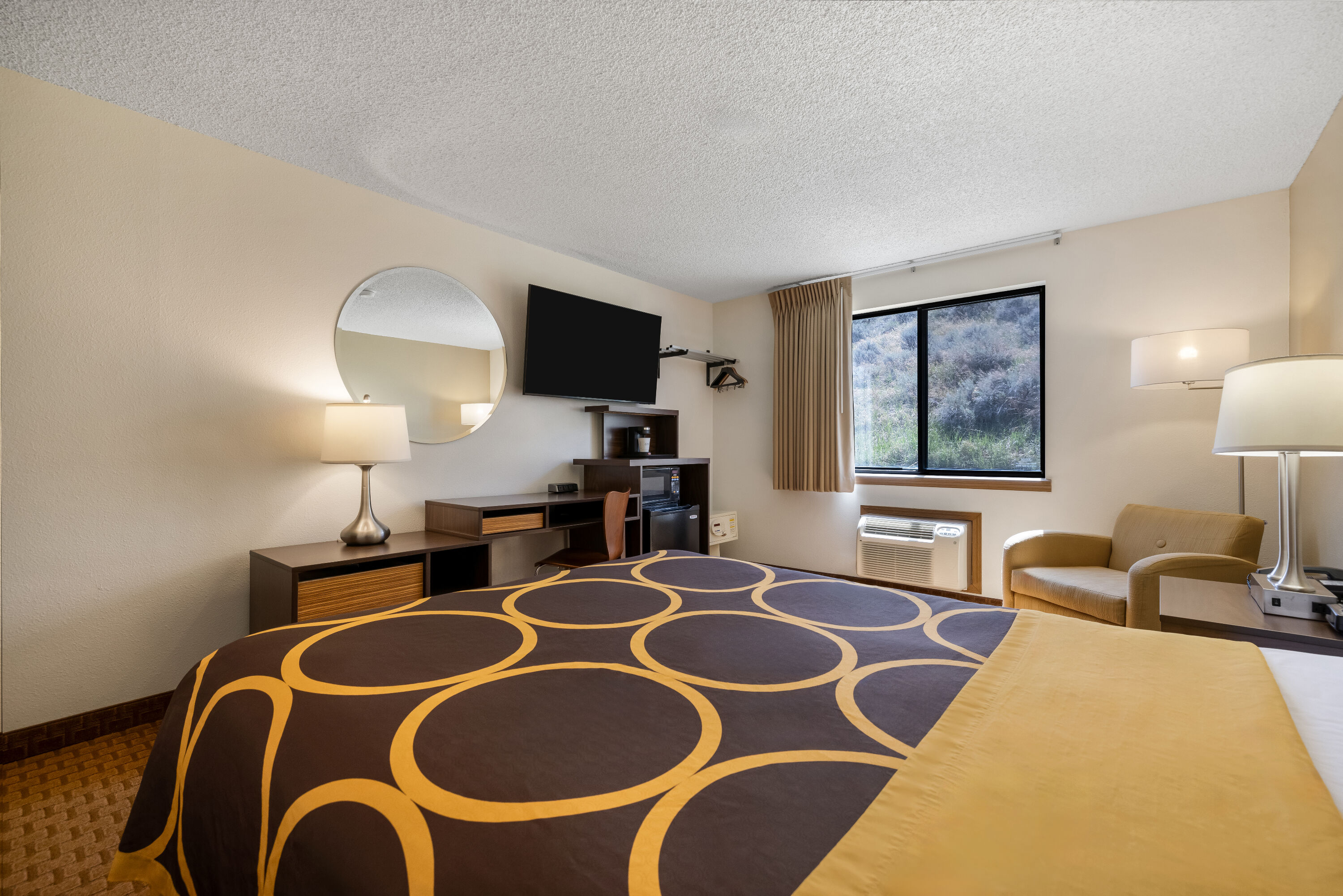 Queen bed guest room at the Super 8 by Wyndham Cody in Cody, Wyoming