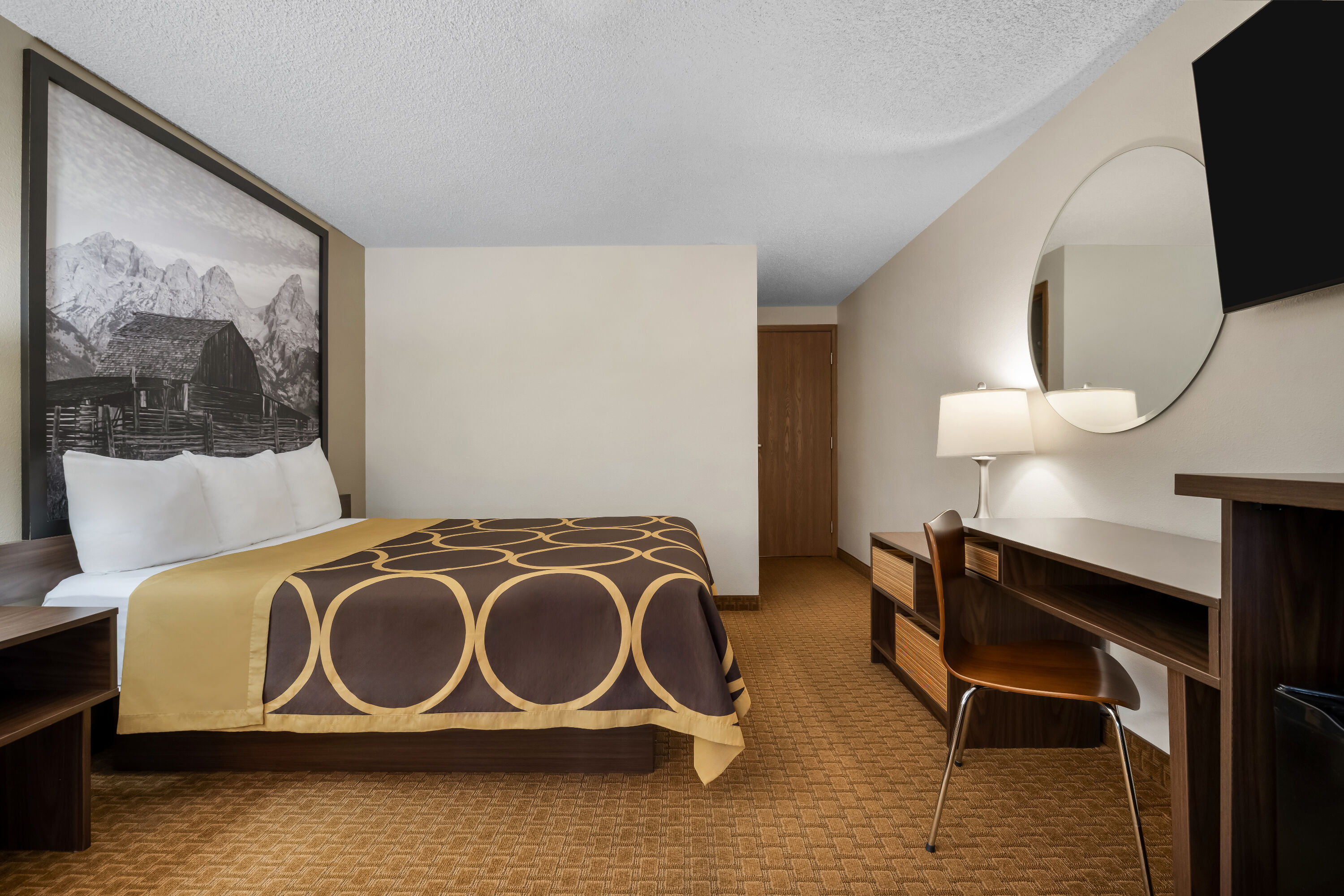 Queen bed guest room at the Super 8 by Wyndham Cody in Cody, Wyoming
