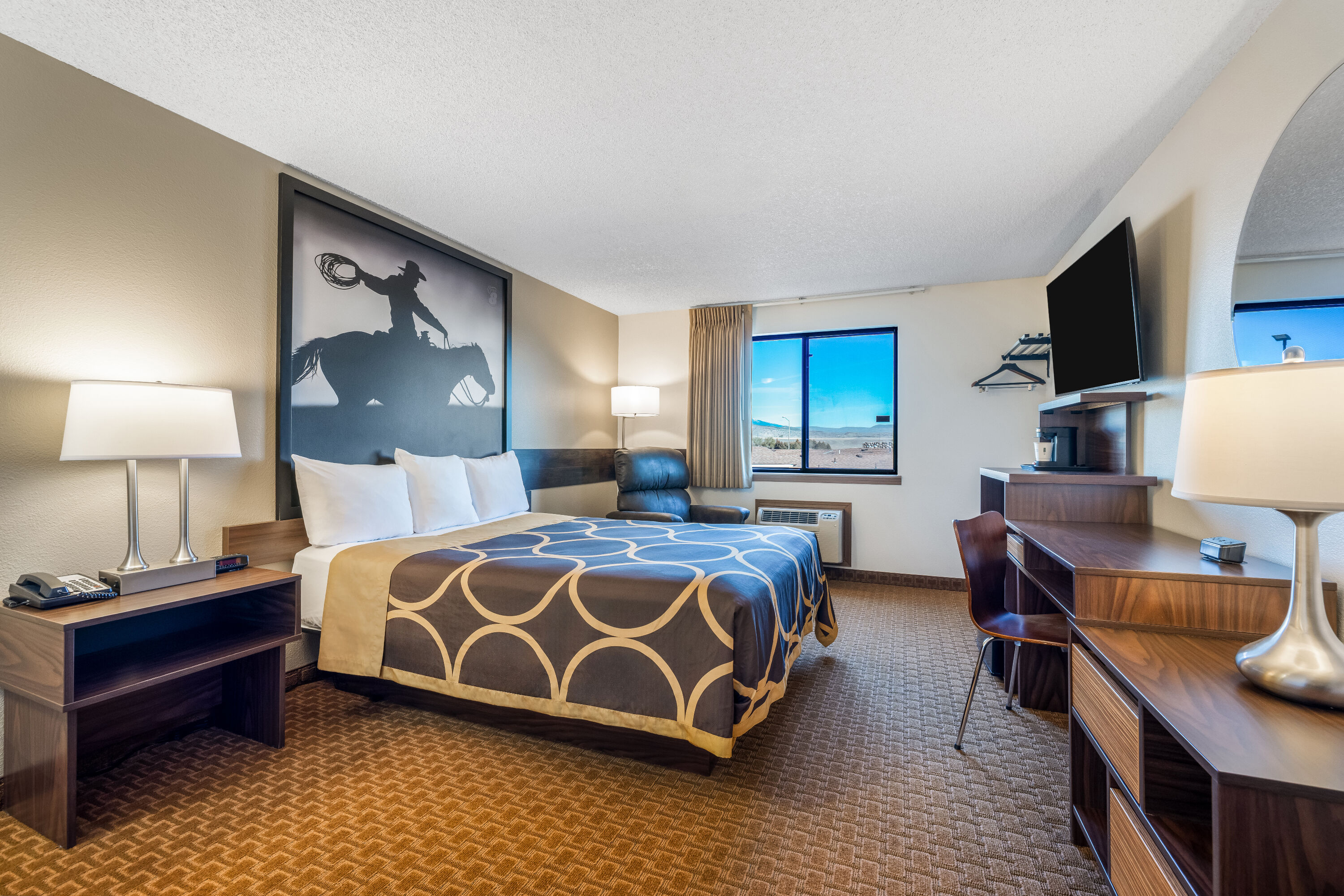 Queen bed guest room at the Super 8 by Wyndham Cody in Cody, Wyoming