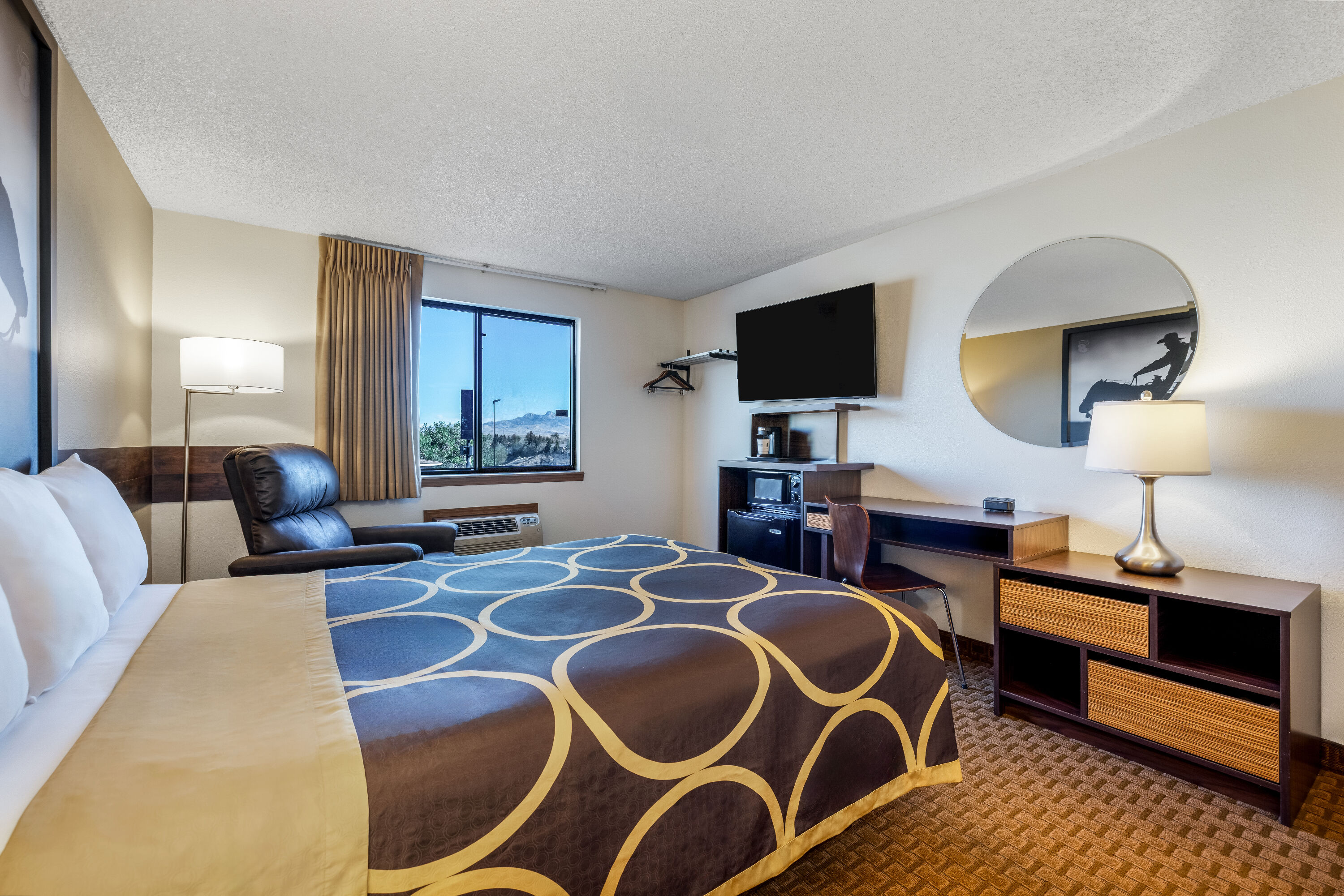 Queen bed guest room at the Super 8 by Wyndham Cody in Cody, Wyoming