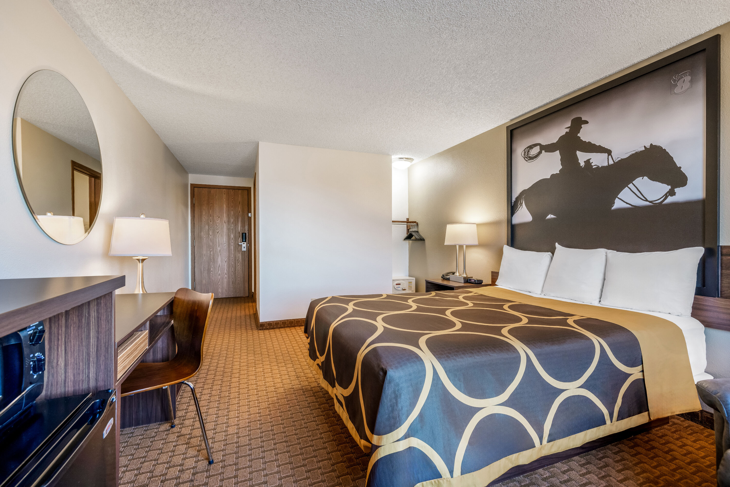 Queen bed guest room at the Super 8 by Wyndham Cody in Cody, Wyoming