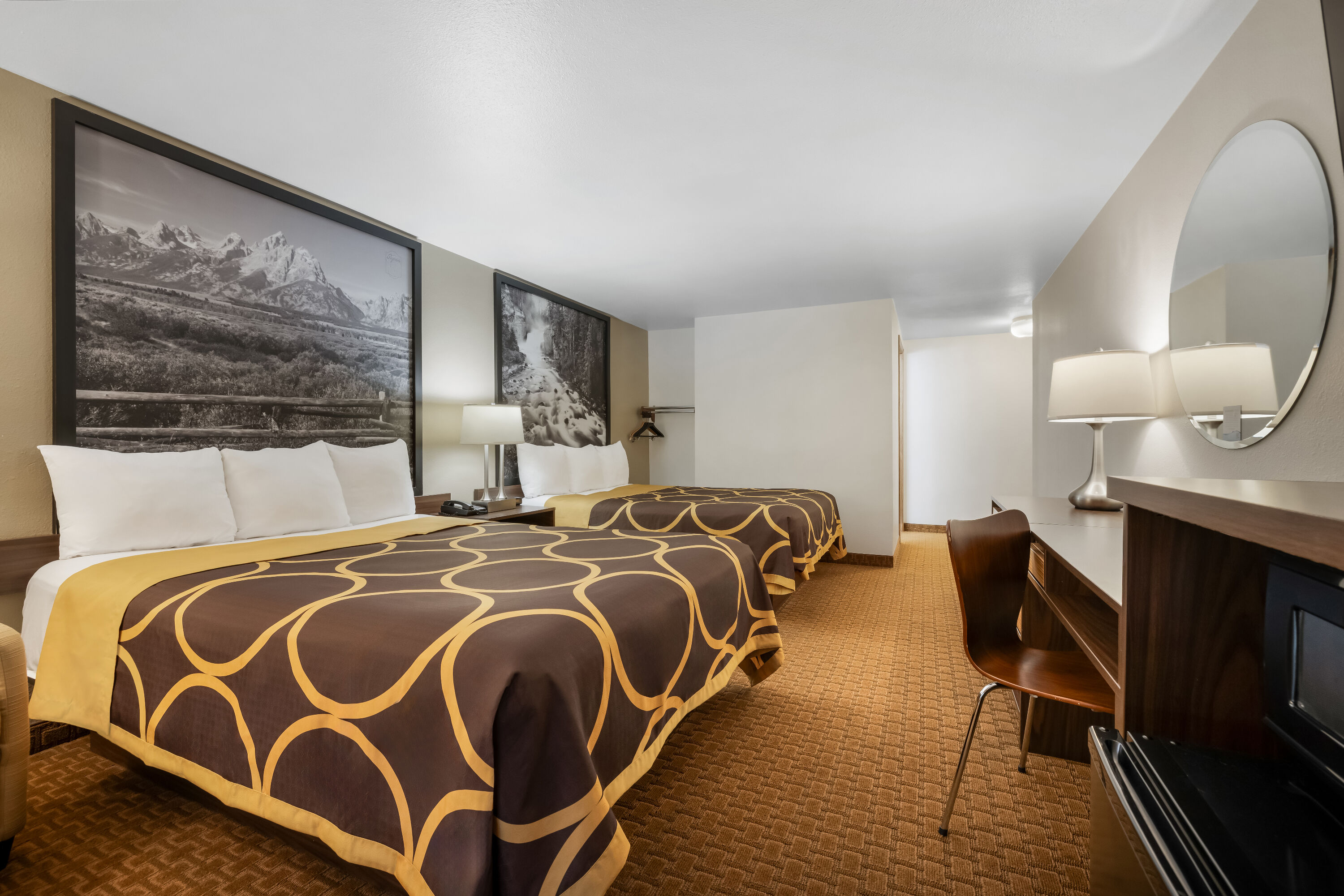 Queen bed guest room at the Super 8 by Wyndham Cody in Cody, Wyoming