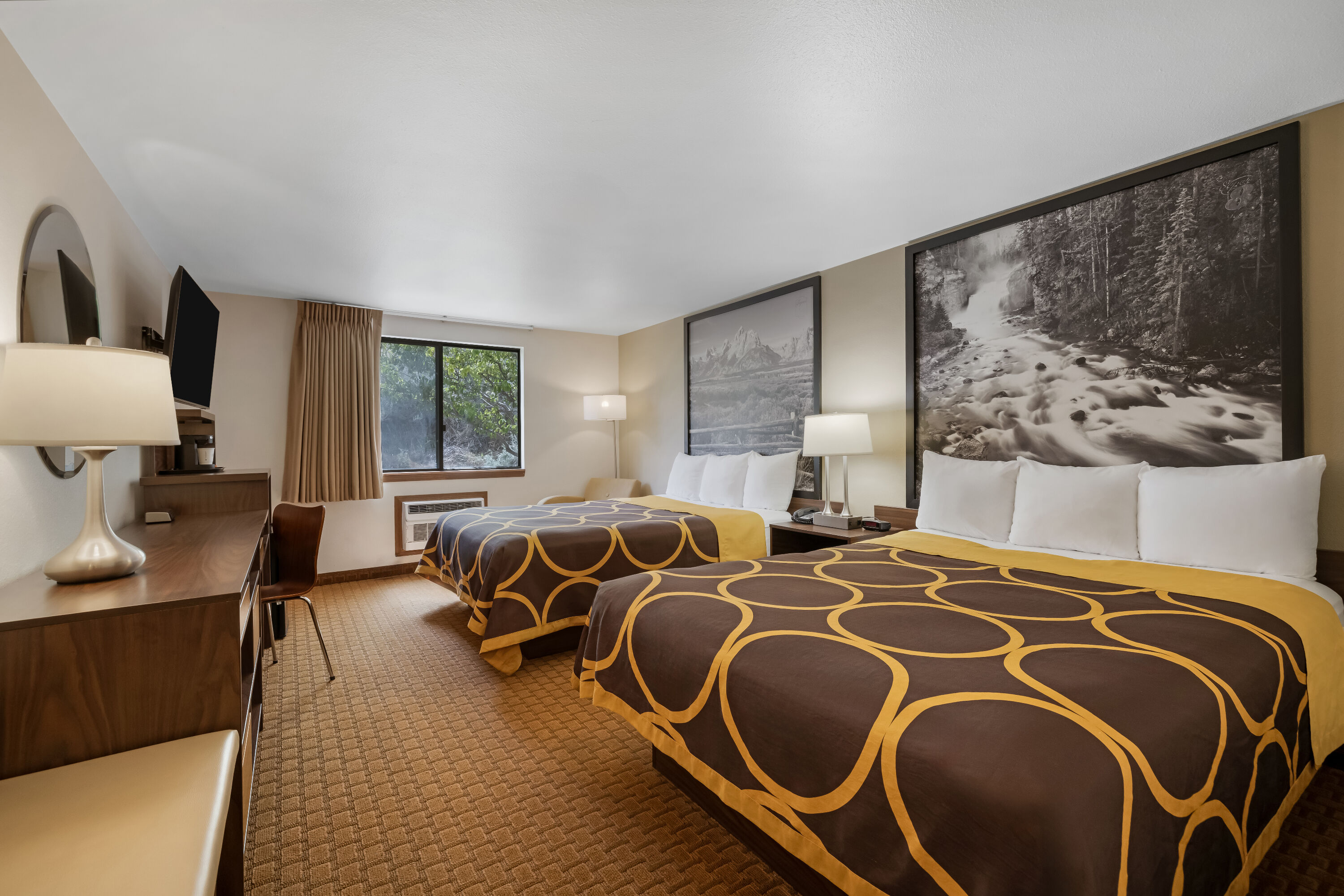 Queen bed guest room at the Super 8 by Wyndham Cody in Cody, Wyoming