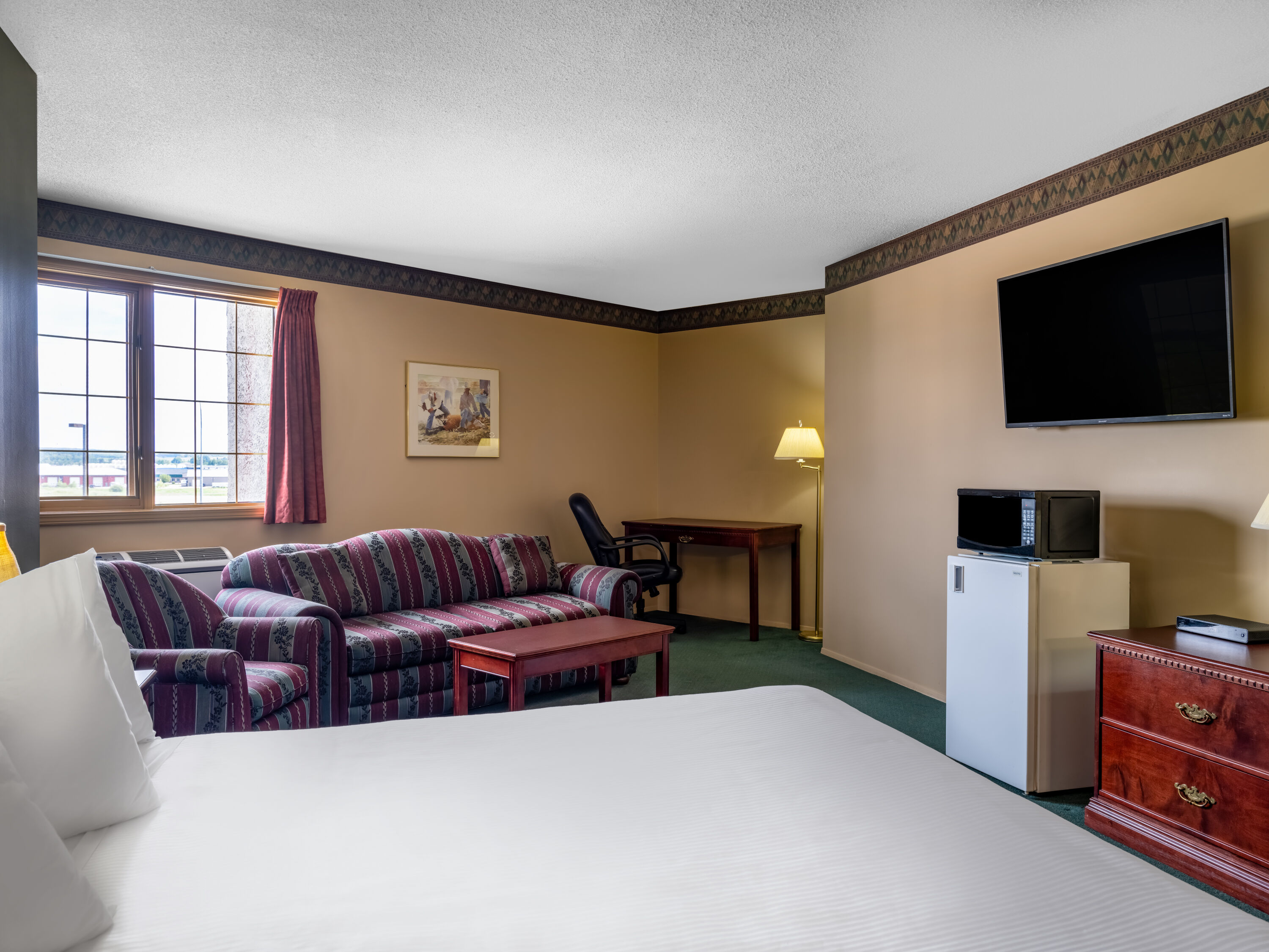 Guest room at the Travelodge by Wyndham Lacombe in Lacombe, Alberta