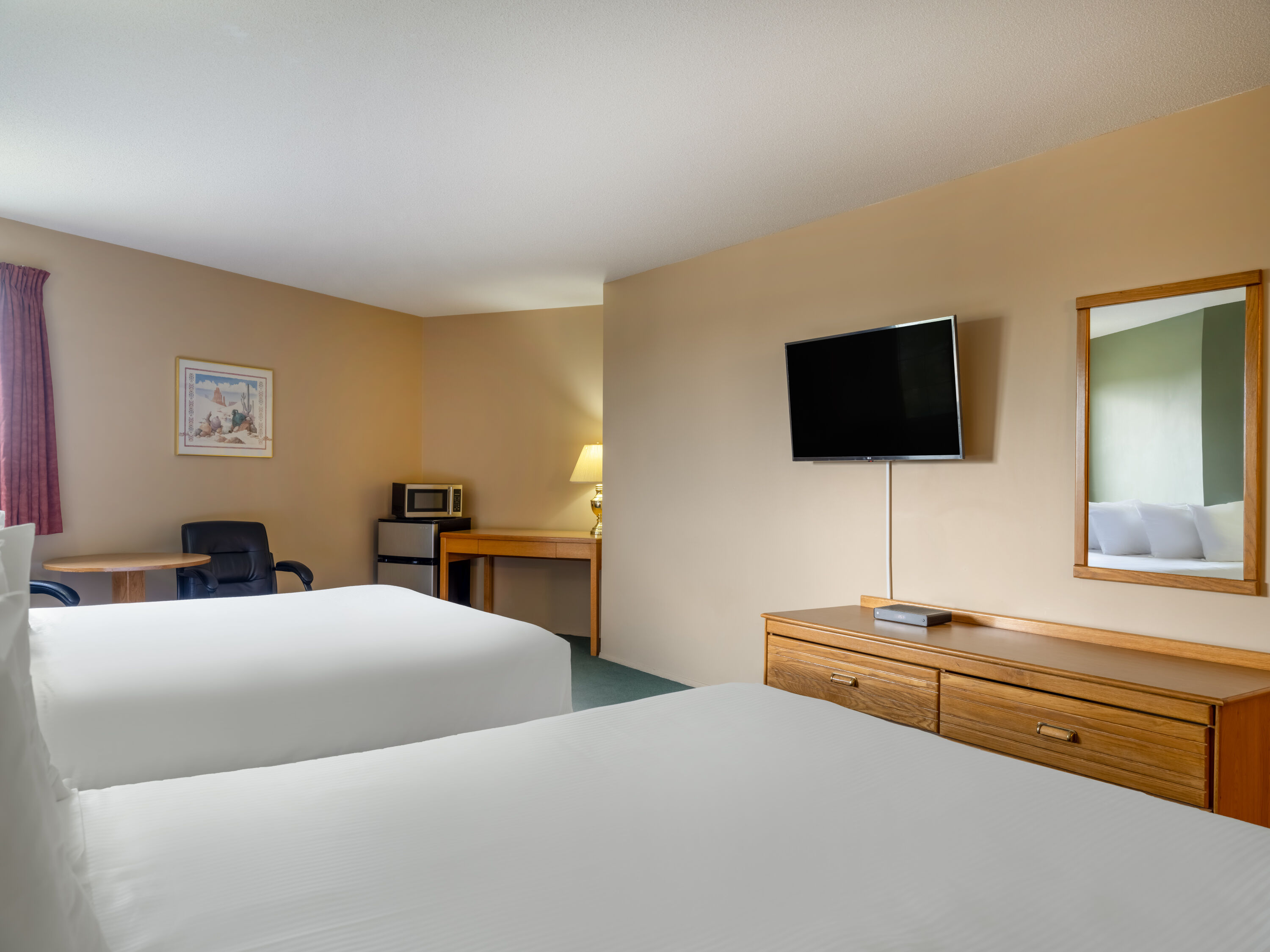 Guest room at the Travelodge by Wyndham Lacombe in Lacombe, Alberta