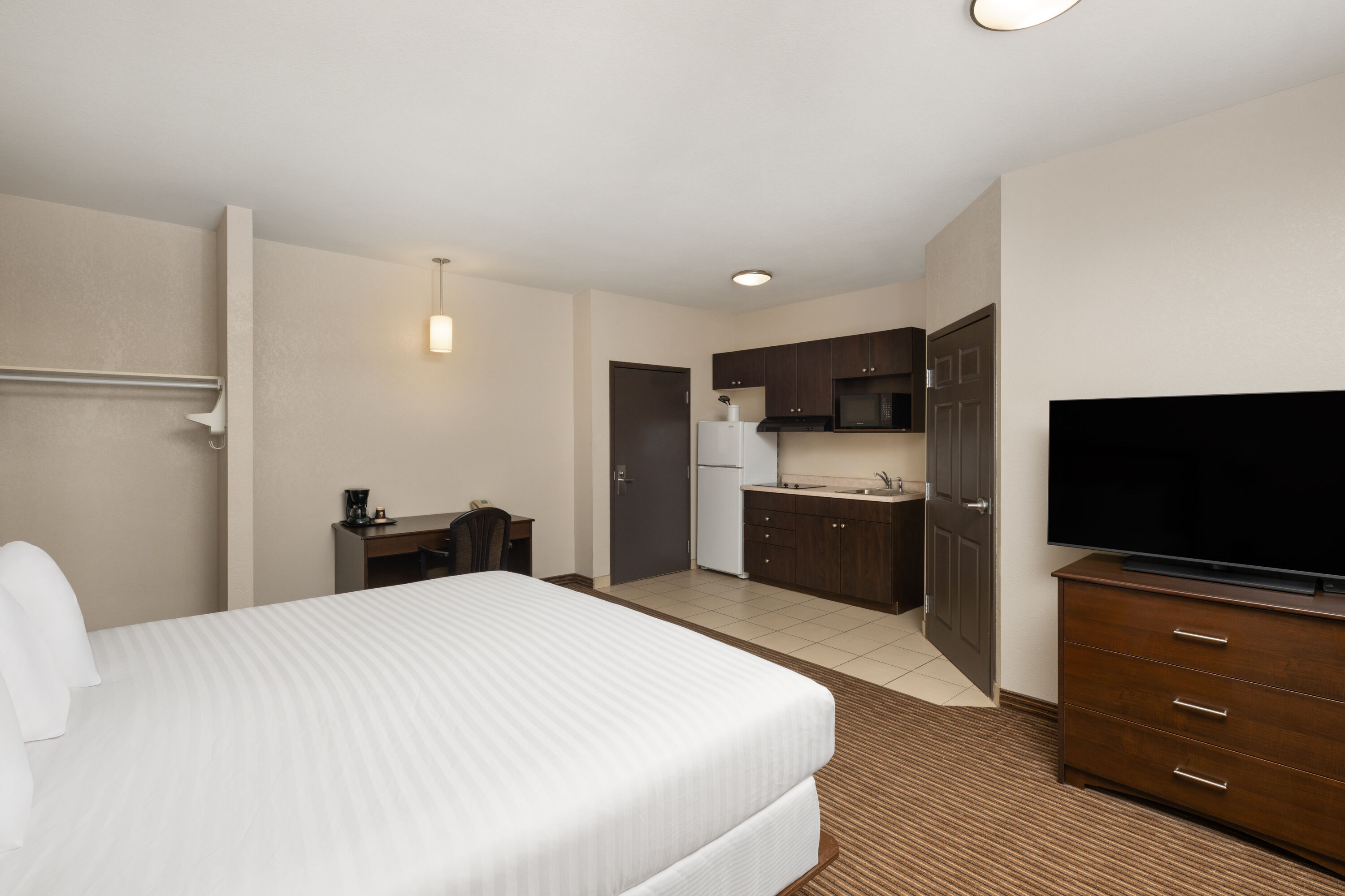 Guest room at the Travelodge Suites by Wyndham Estevan in Estevan, Saskatchewan