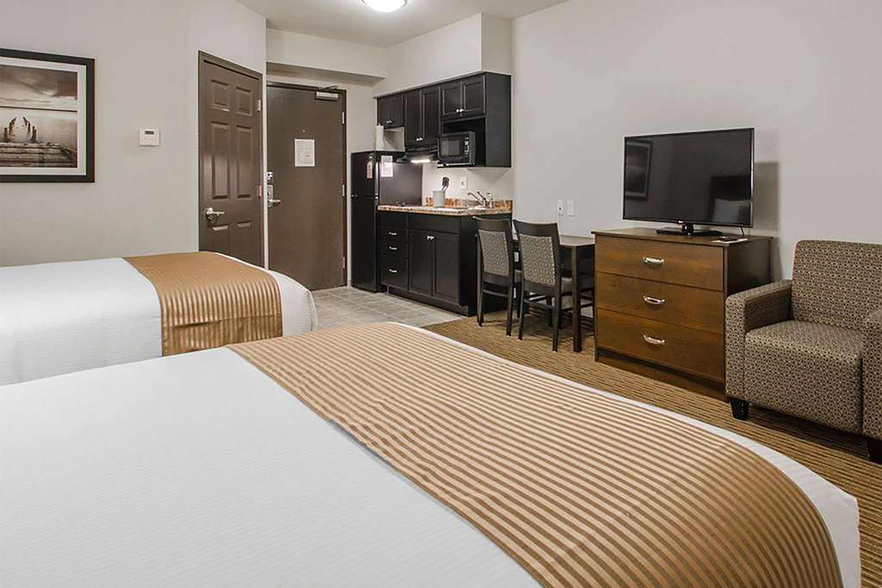 Guest room at the Travelodge Suites by Wyndham Estevan in Estevan, Saskatchewan