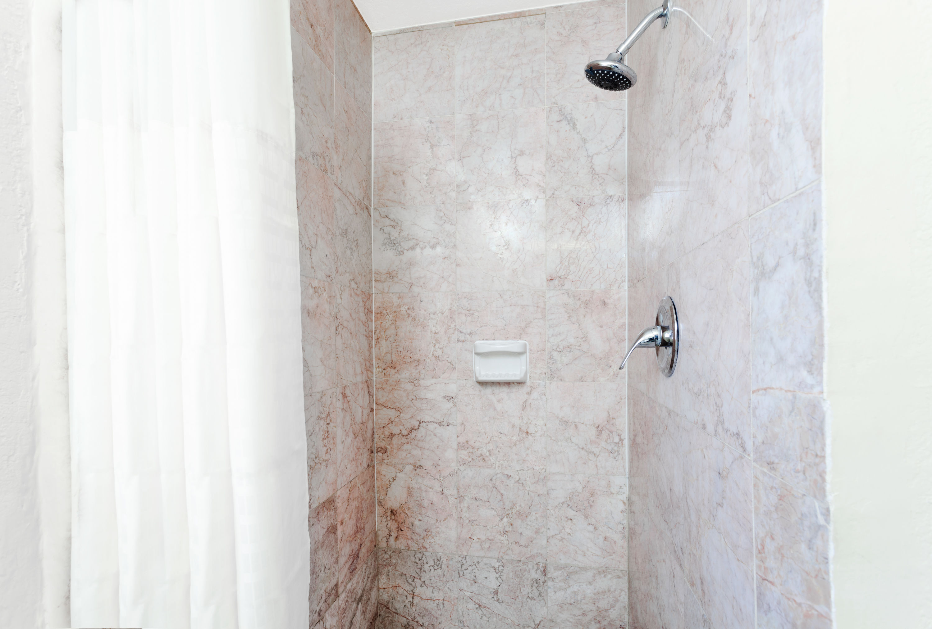 Guest room bath at the Travelodge by Wyndham El Cajon in El Cajon, California