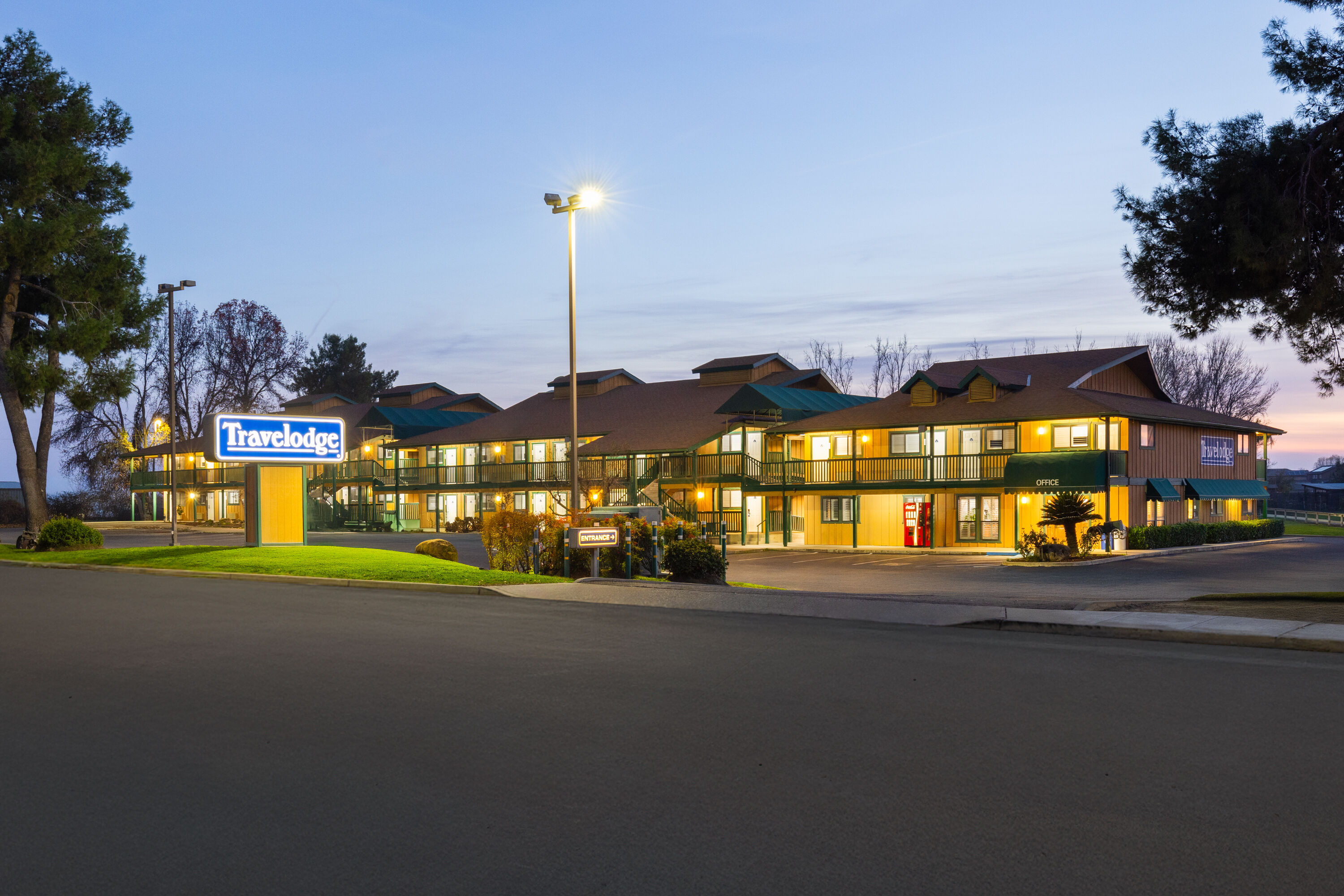 Exterior Dusk Image of Travelodge by Wyndham Lemoore Near Naval Air Station hotel in Lemoore, California