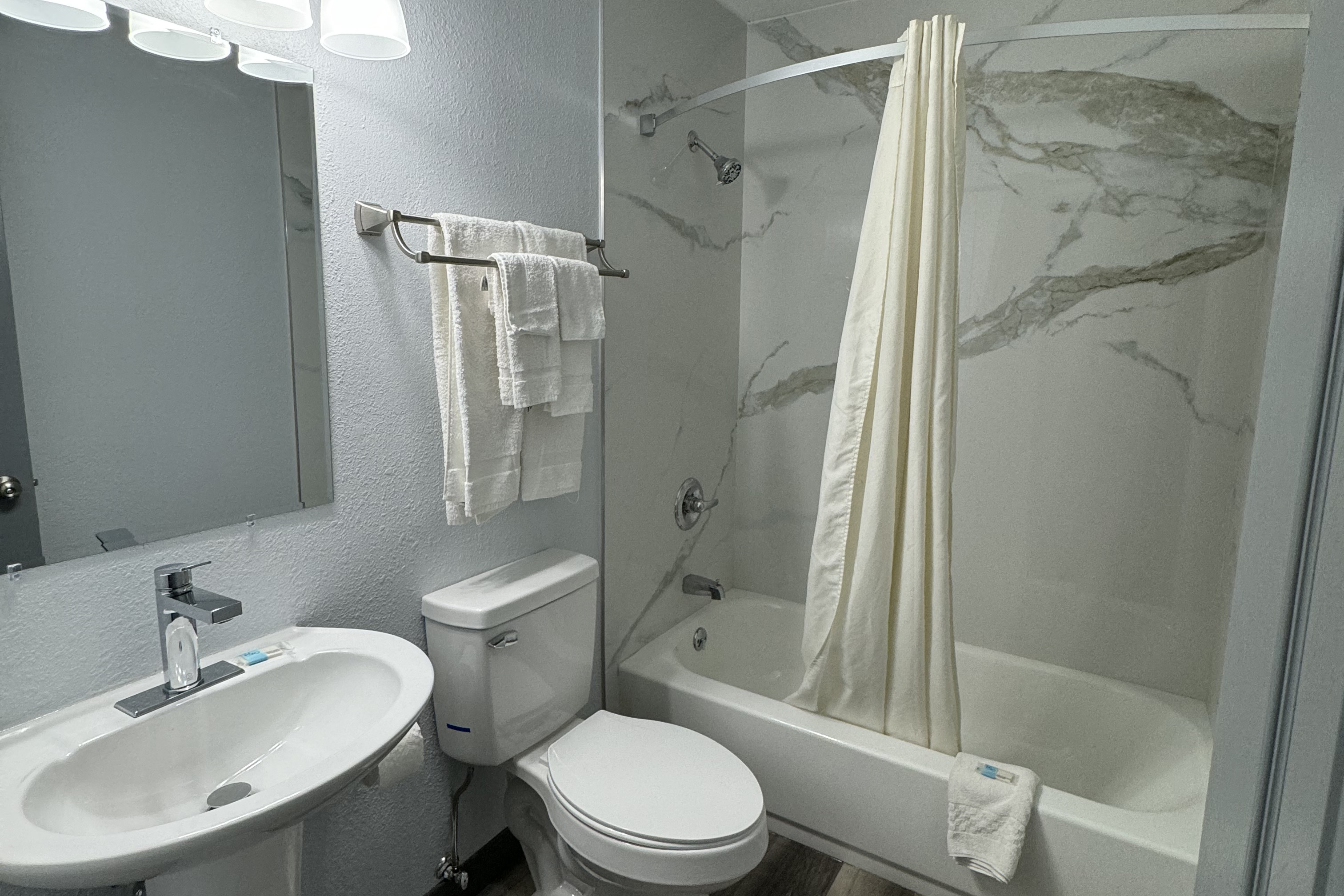 Guest room bath at the Travelodge by Wyndham Gainesville in Gainesville, Florida