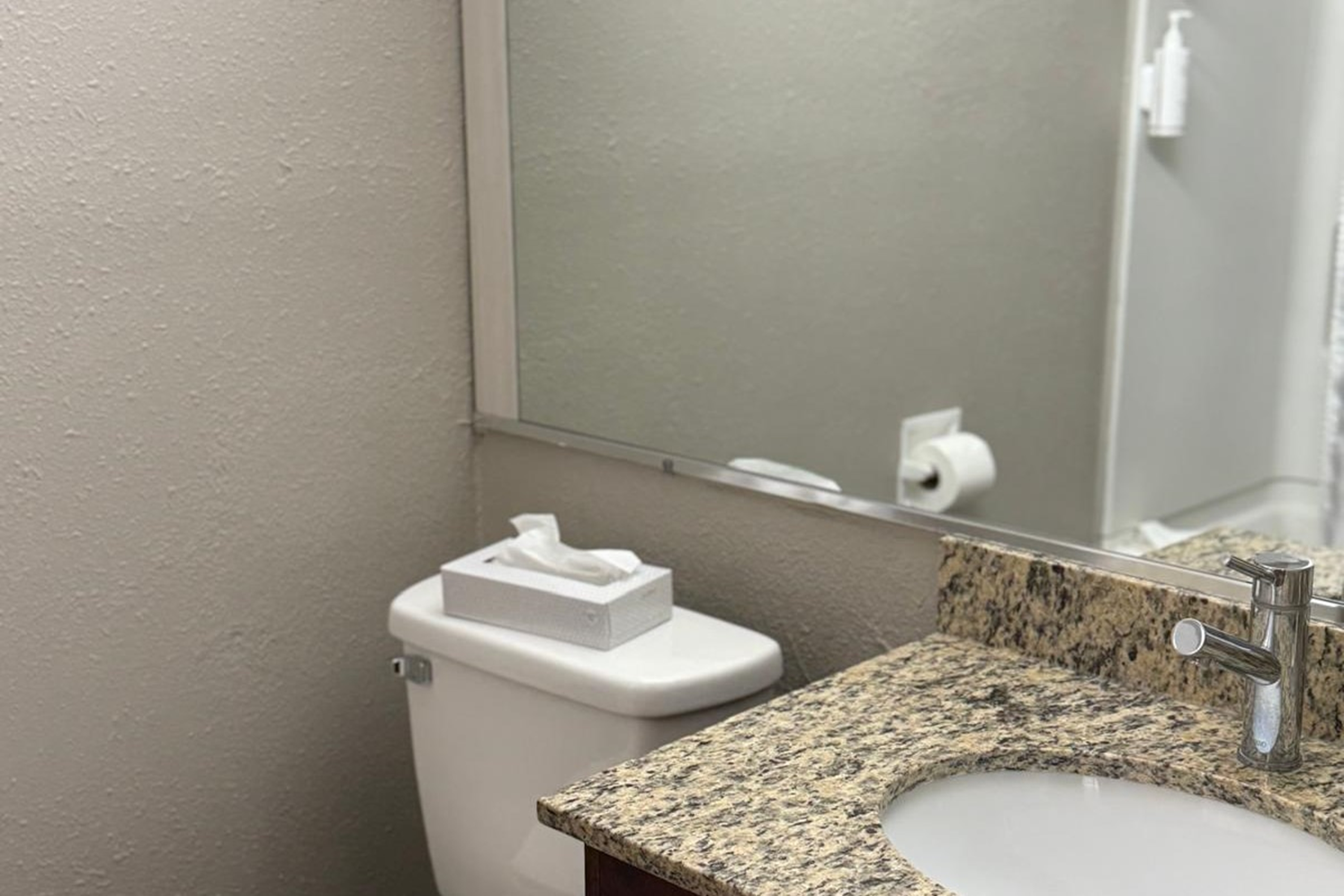 Guest room bath at the Travelodge by Wyndham Lakeland in Lakeland, Florida