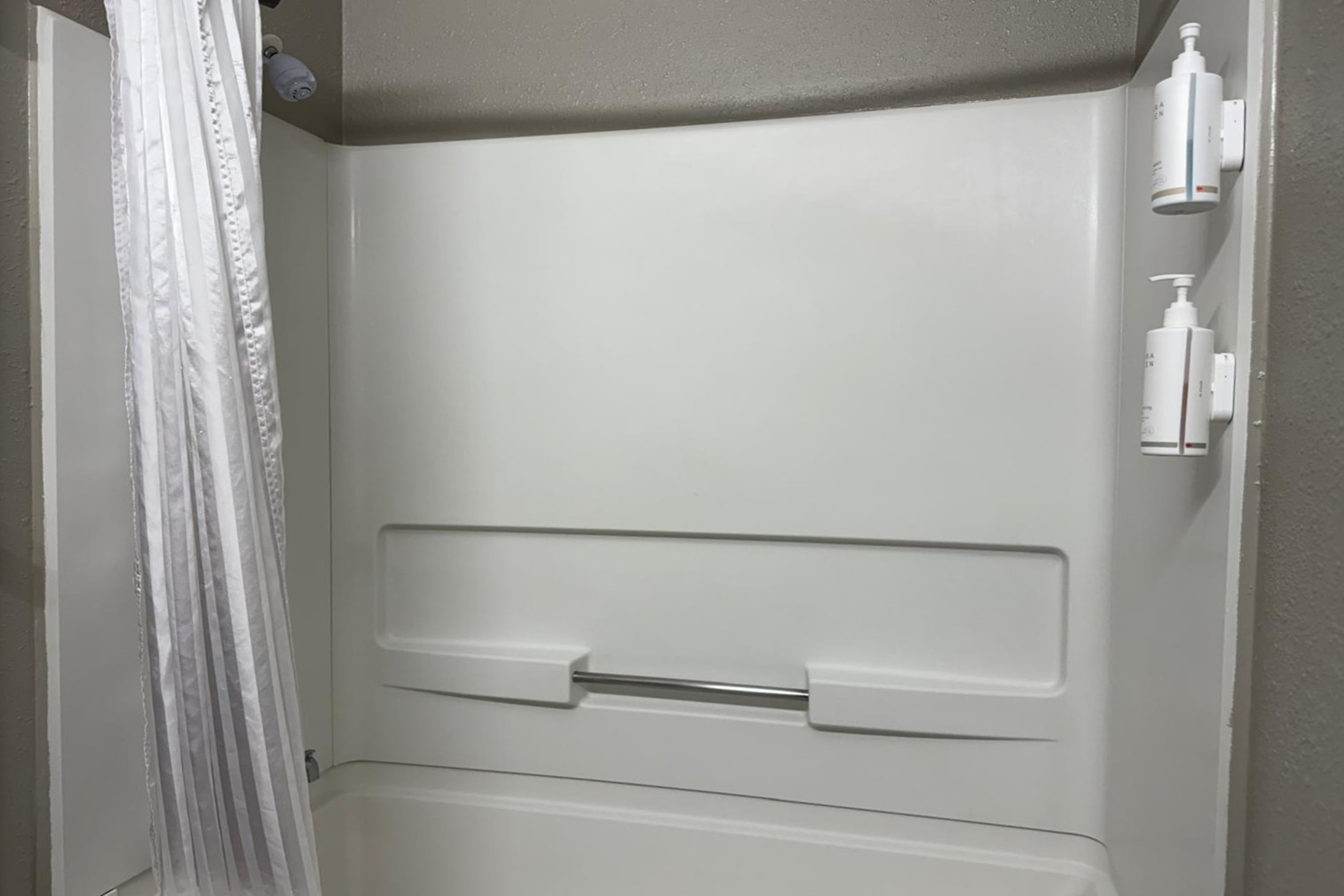 Guest room bath at the Travelodge by Wyndham Lakeland in Lakeland, Florida