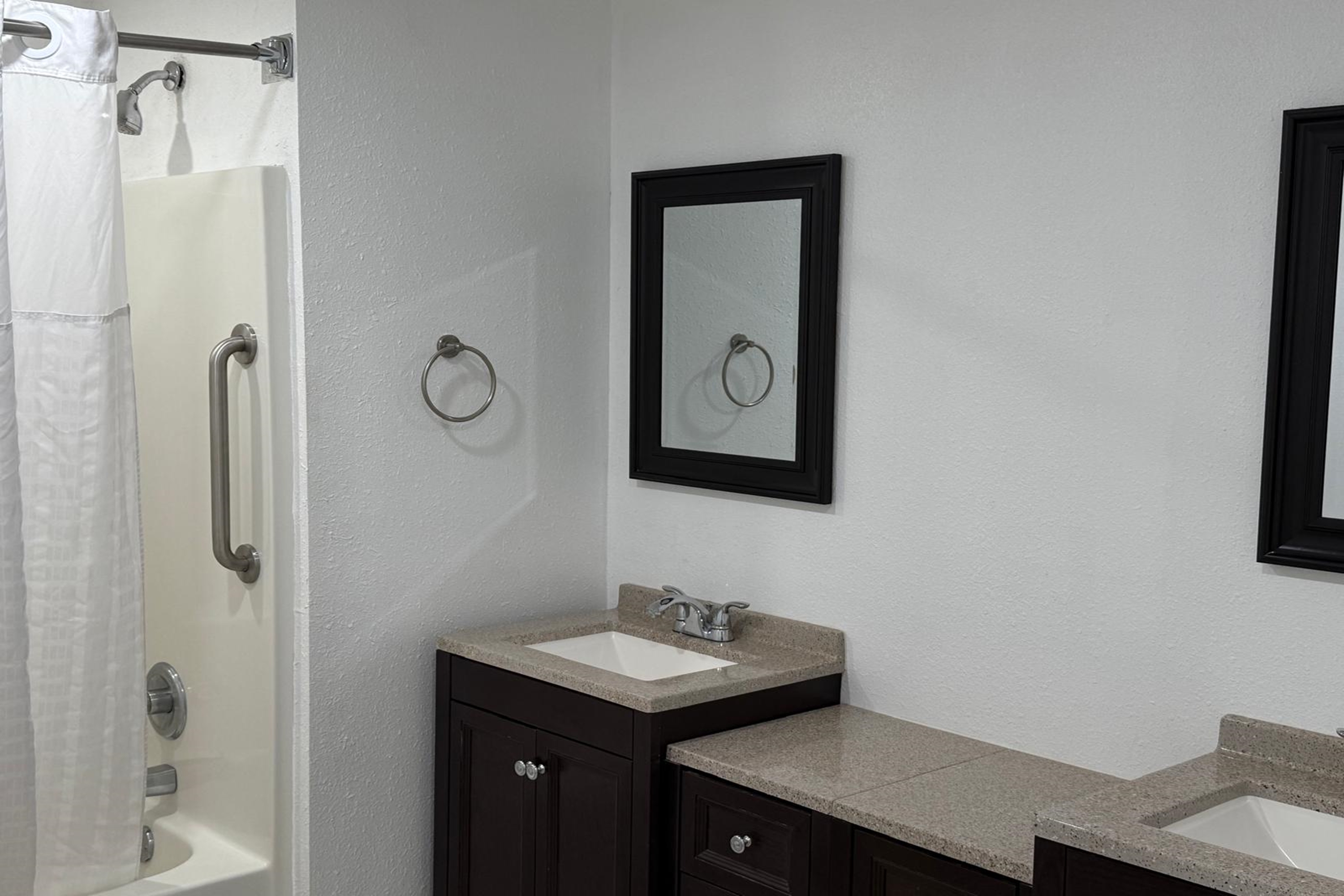 Guest room bath at the Travelodge by Wyndham Lakeland in Lakeland, Florida