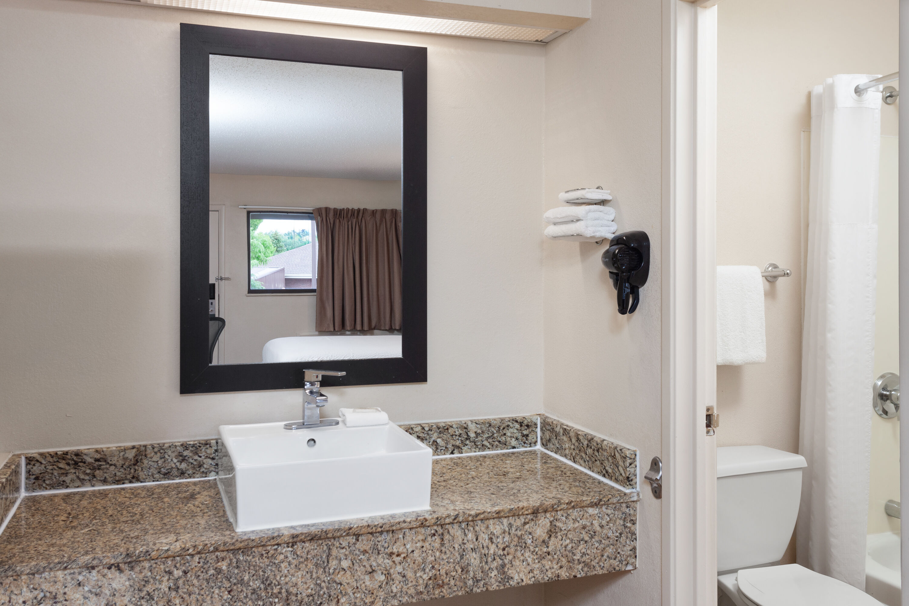 Guest room bath at the Travelodge by Wyndham Peoria in Peoria, Illinois