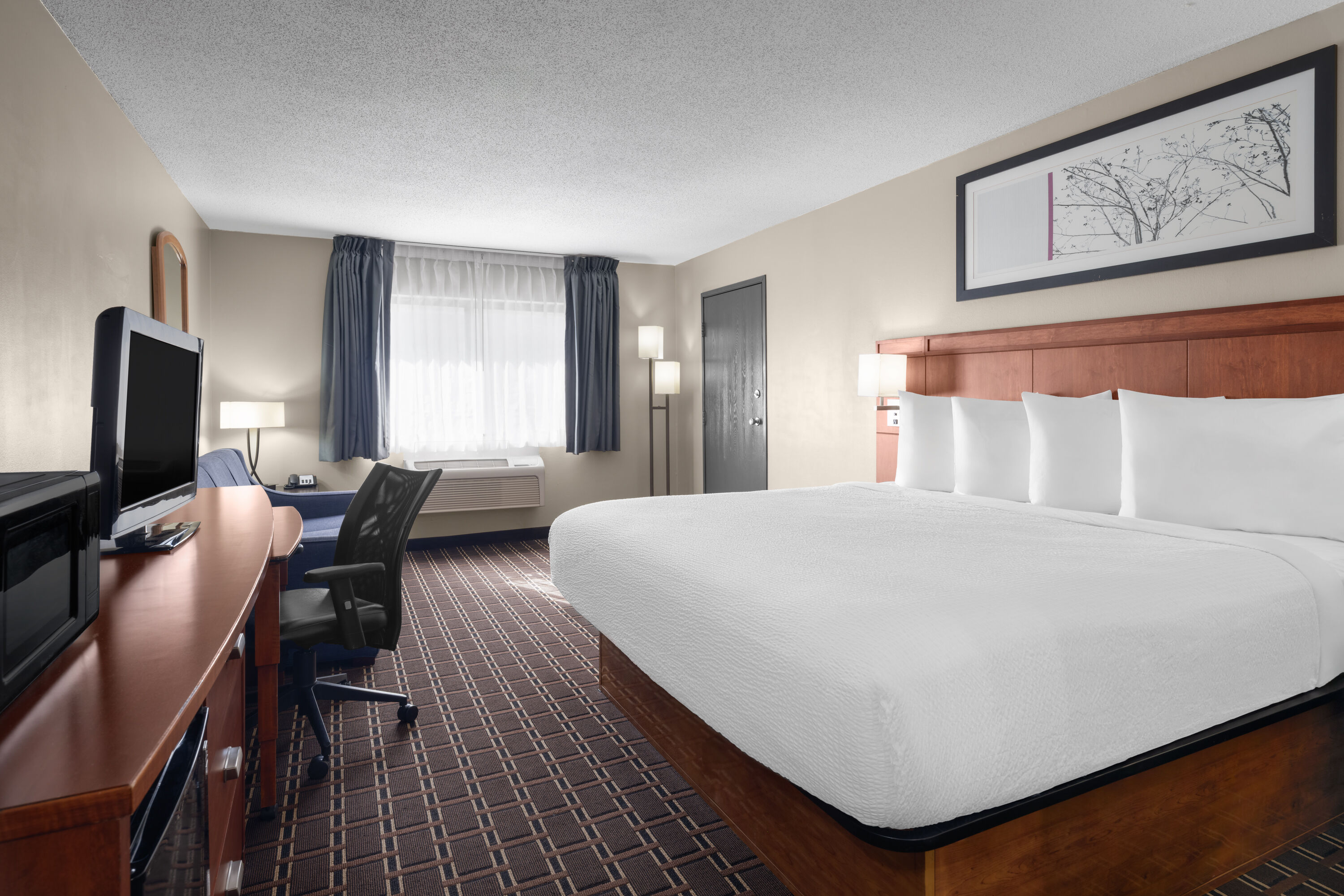 Guest room at the Travelodge by Wyndham Fargo West Acres in Fargo, North Dakota