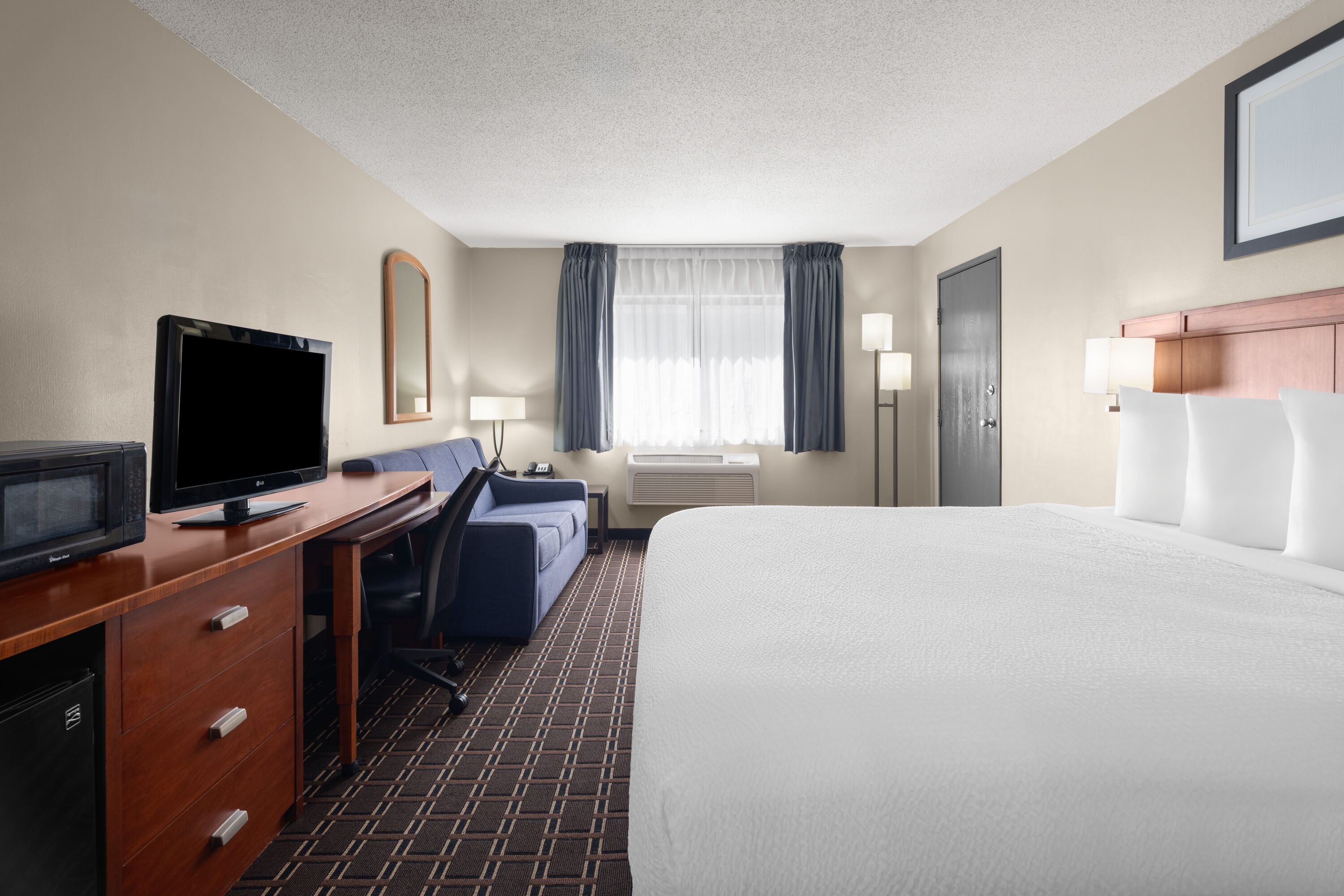 Guest room at the Travelodge by Wyndham Fargo West Acres in Fargo, North Dakota