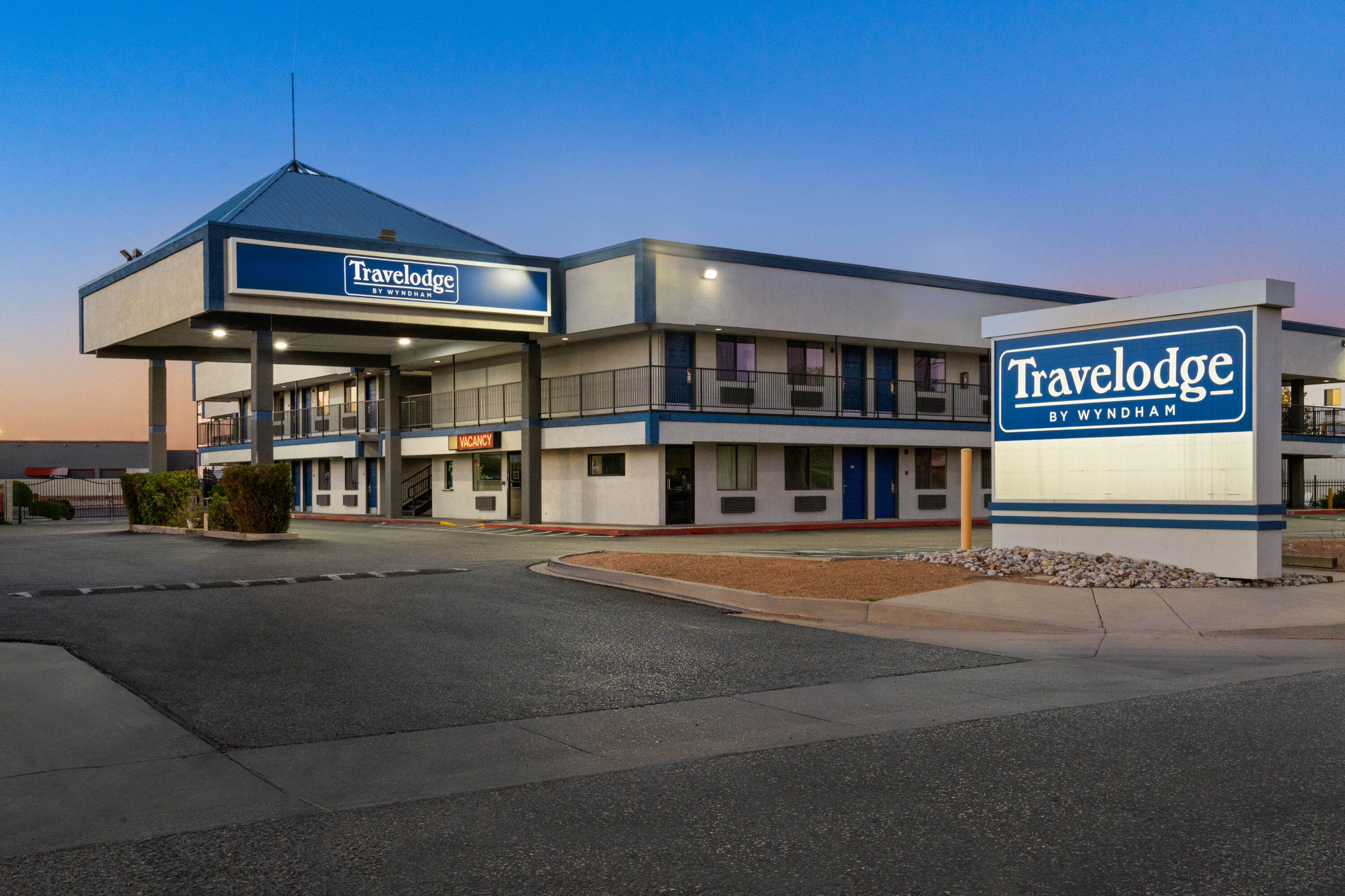 Exterior Dusk Image of Travelodge by Wyndham Albuquerque West hotel in Albuquerque, New Mexico