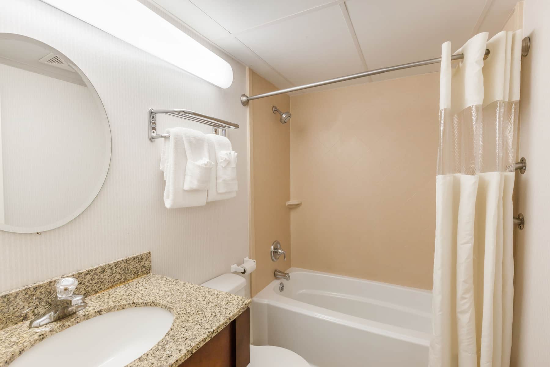 Guest room bath at the Travelodge Inn & Suites by Wyndham Albany in Albany, New York
