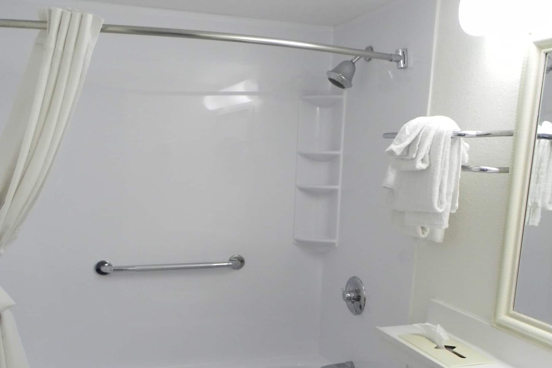 Guest room bath at the Travelodge Inn & Suites by Wyndham Albany in Albany, New York