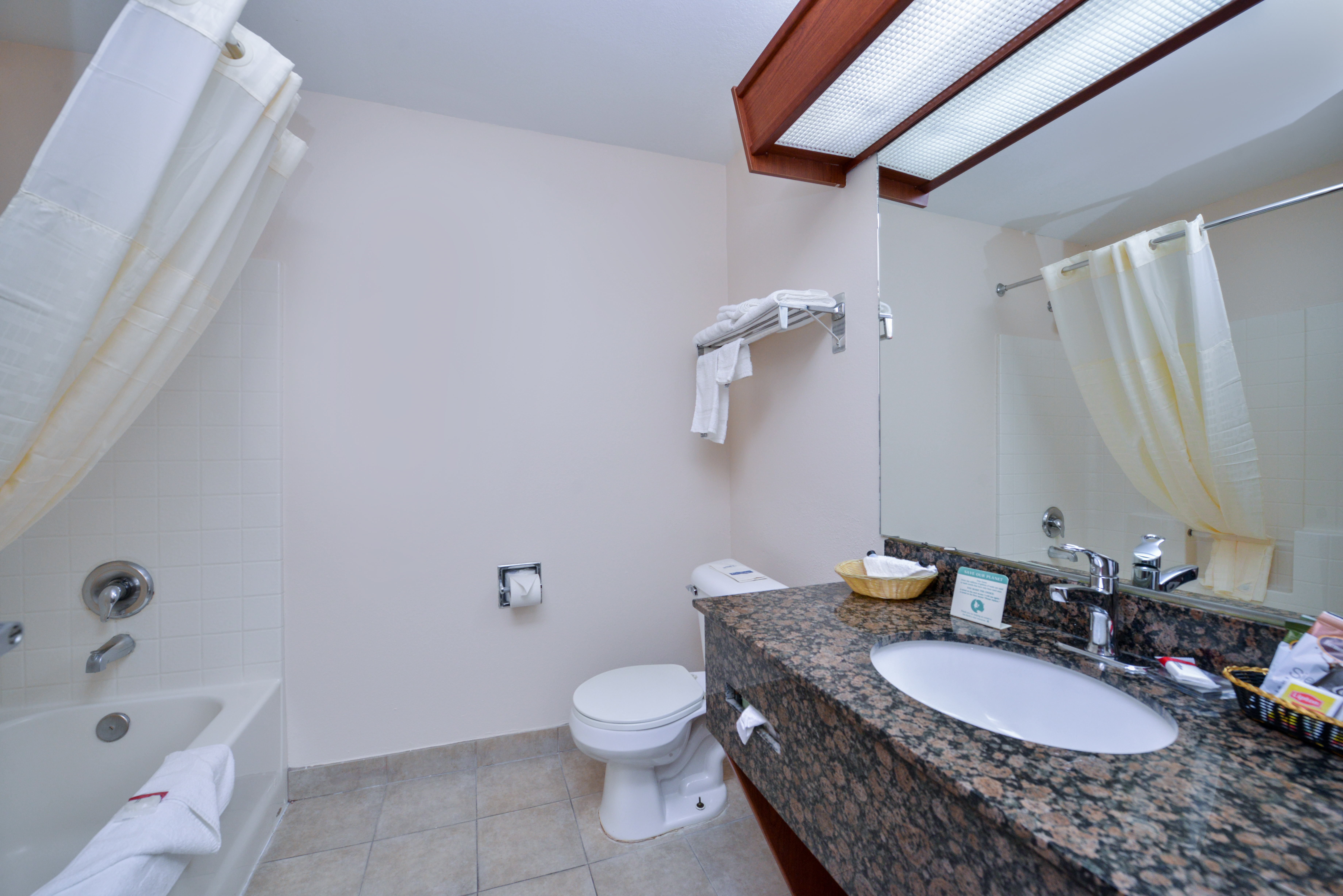 Guest room bath at the Travelodge Suites by Wyndham Newberg in Newberg, Oregon