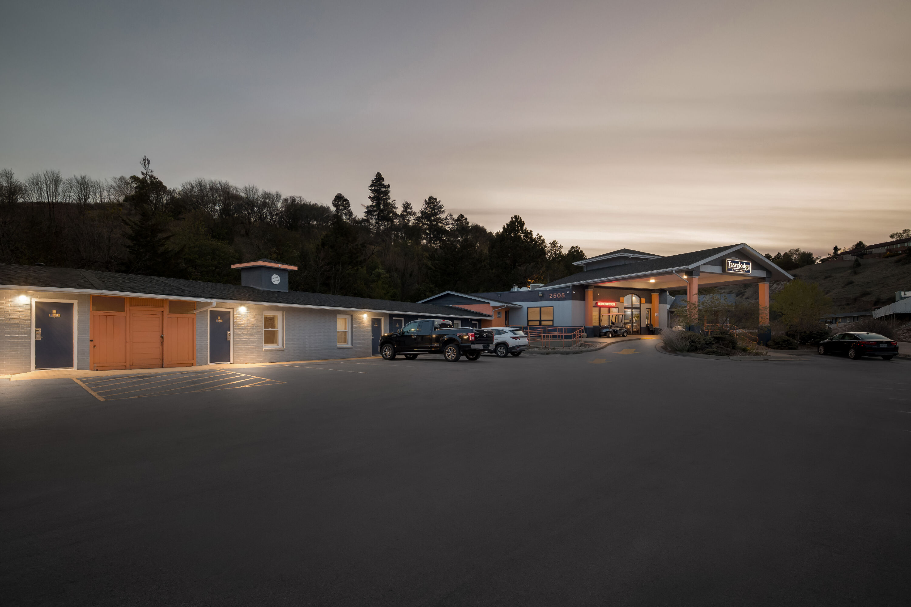 Exterior Night Image of Travelodge by Wyndham Rapid City hotel in Rapid City, South Dakota