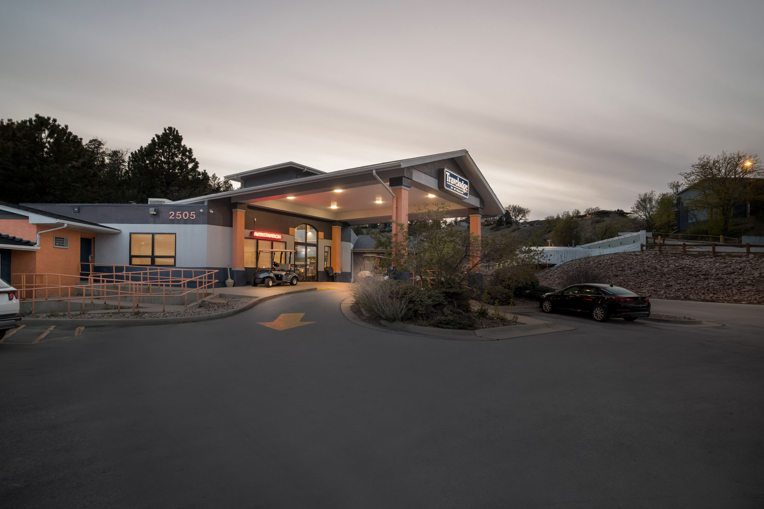 Exterior Night Image of Travelodge by Wyndham Rapid City hotel in Rapid City, South Dakota