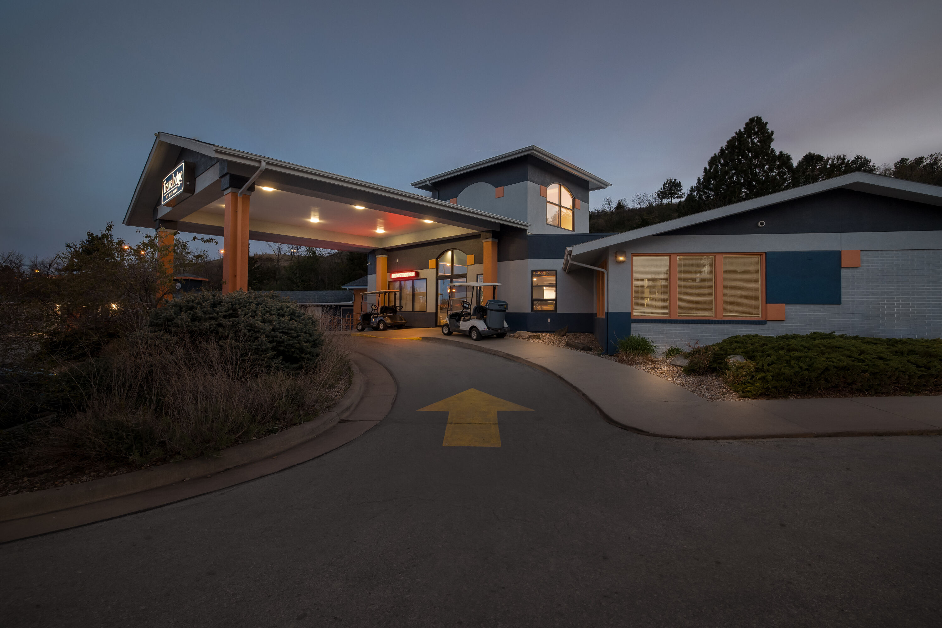 Exterior Night Image of Travelodge by Wyndham Rapid City hotel in Rapid City, South Dakota
