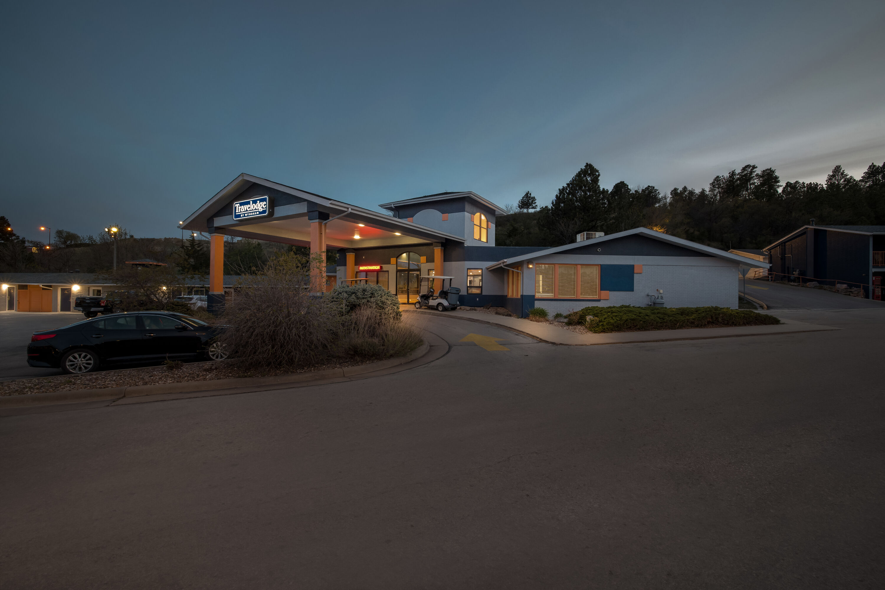 Exterior Night Image of Travelodge by Wyndham Rapid City hotel in Rapid City, South Dakota