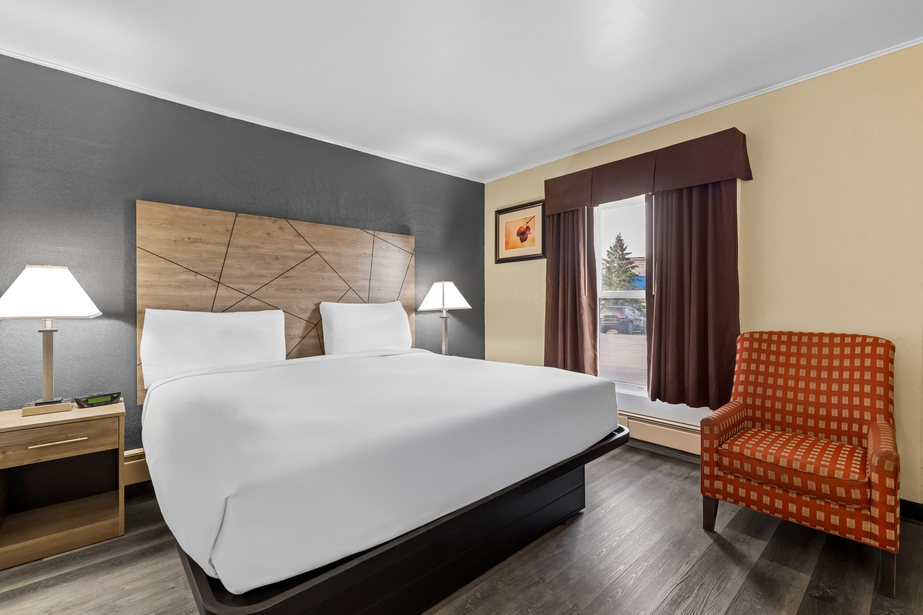 King bed guest room at the Travelodge by Wyndham Rapid City in Rapid City, South Dakota