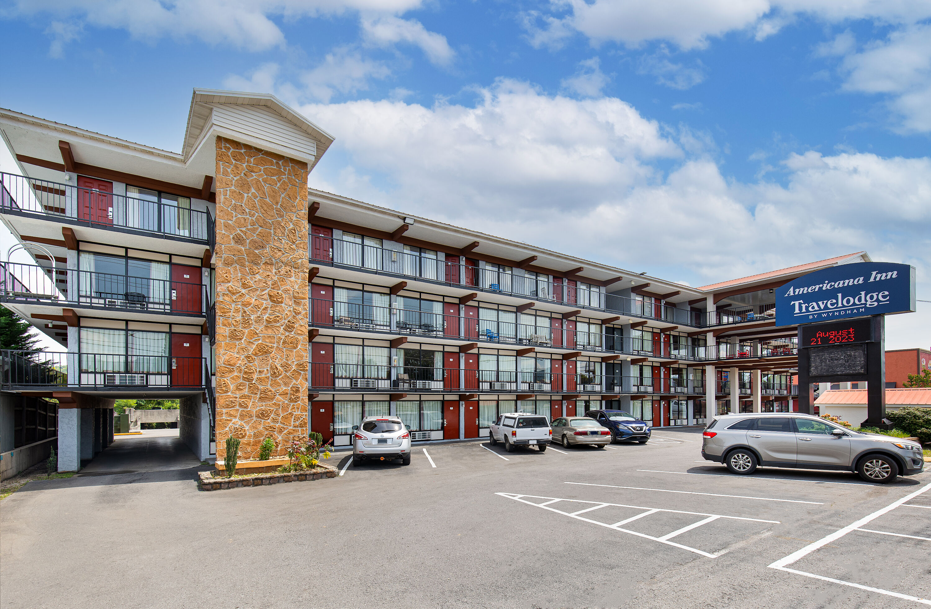 Exterior Day Image of Americana Inn a Travelodge by Wyndham hotel in Pigeon Forge, Tennessee