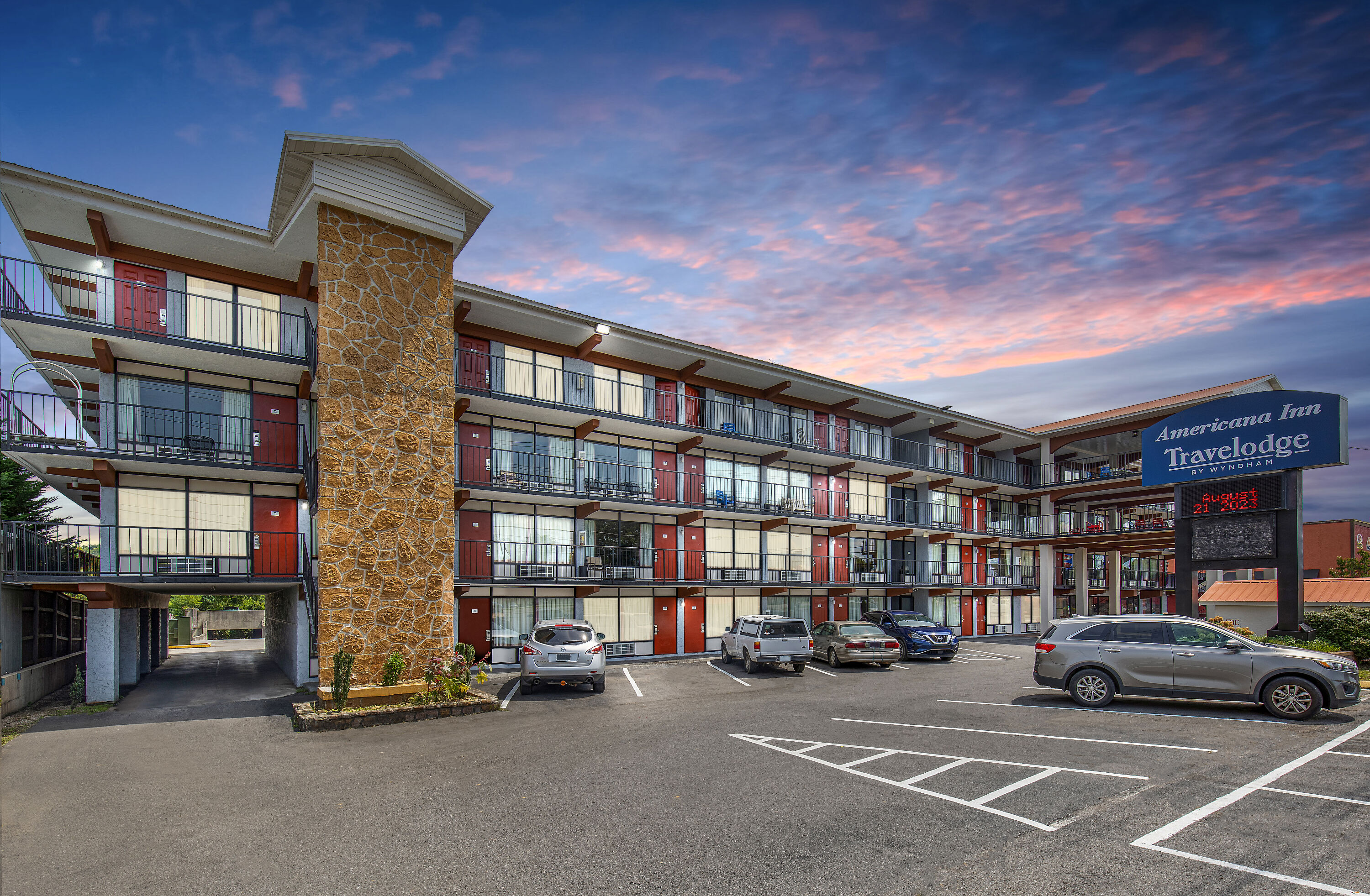 Exterior Dusk Image of Americana Inn a Travelodge by Wyndham hotel in Pigeon Forge, Tennessee