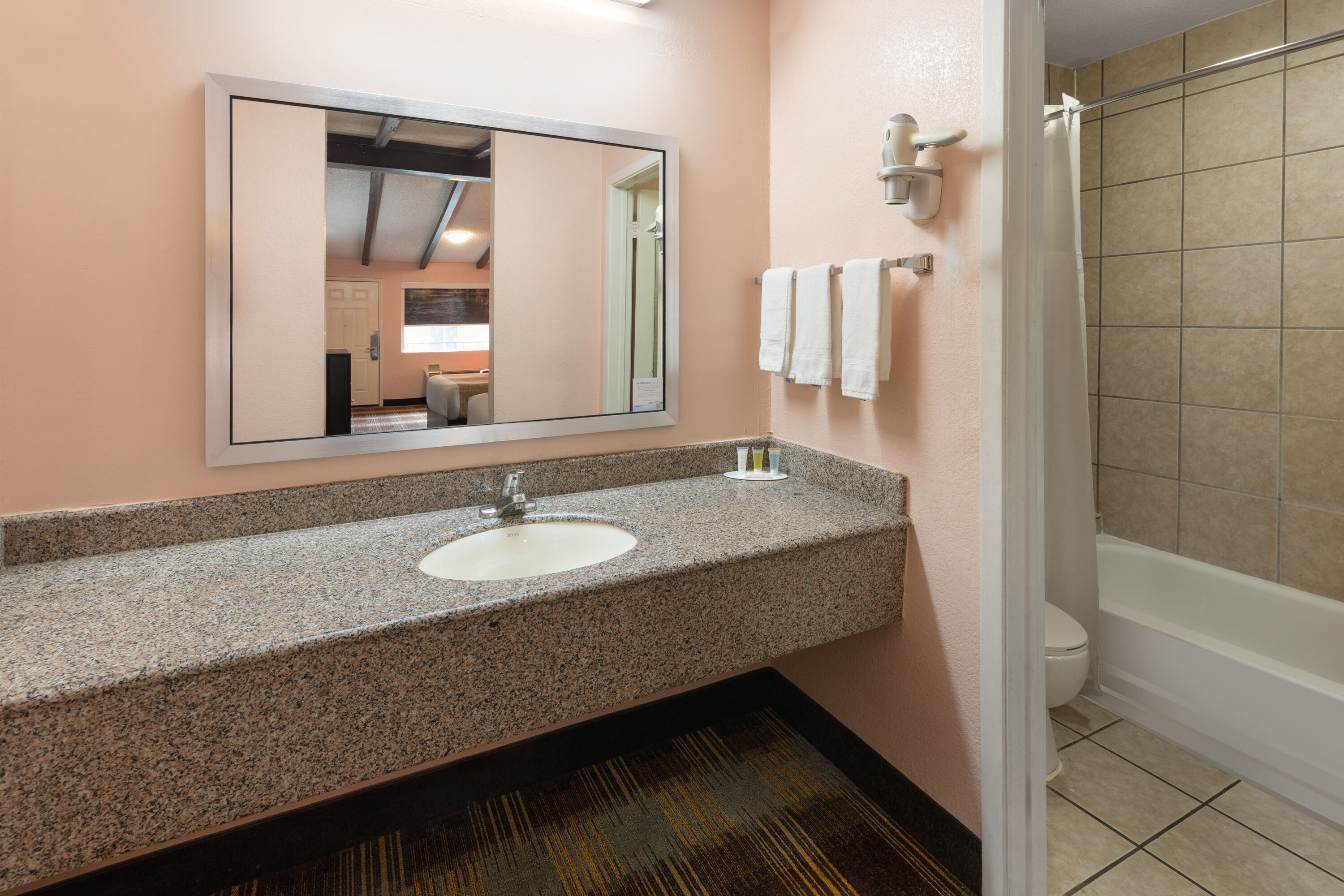 Guest room bath at the Travelodge by Wyndham New Braunfels in New Braunfels, Texas