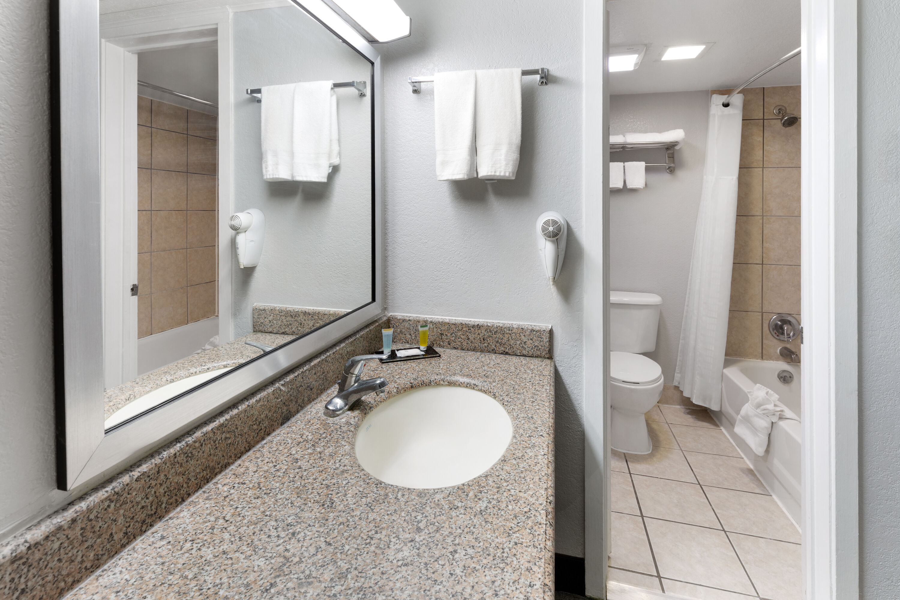 Guest room bath at the Travelodge by Wyndham New Braunfels in New Braunfels, Texas