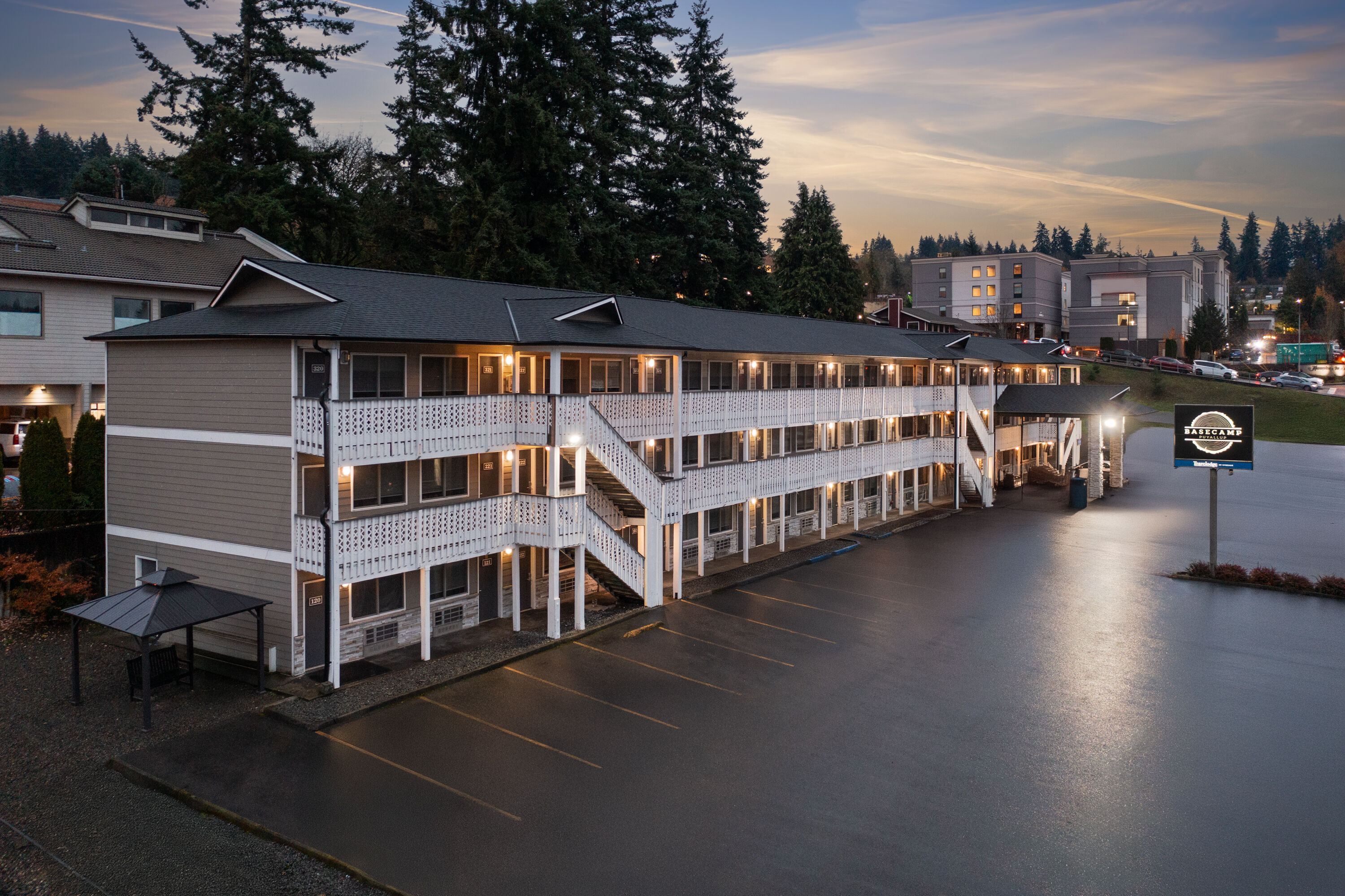Exterior Dusk Image of Basecamp Puyallup a Travelodge by Wyndham hotel in Puyallup, Washington
