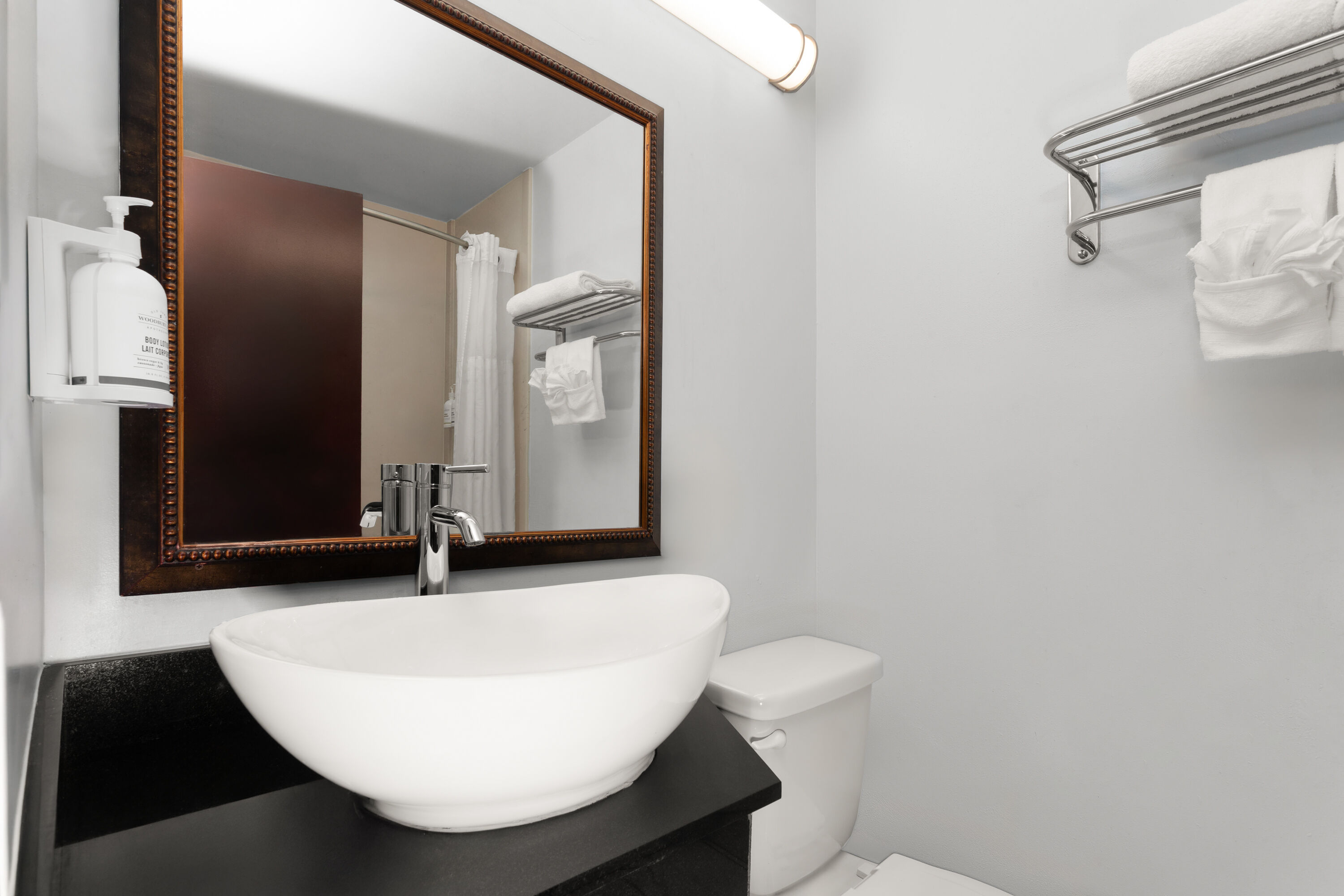 Guest room bath at the Travelodge by Wyndham Milwaukee in Milwaukee, Wisconsin