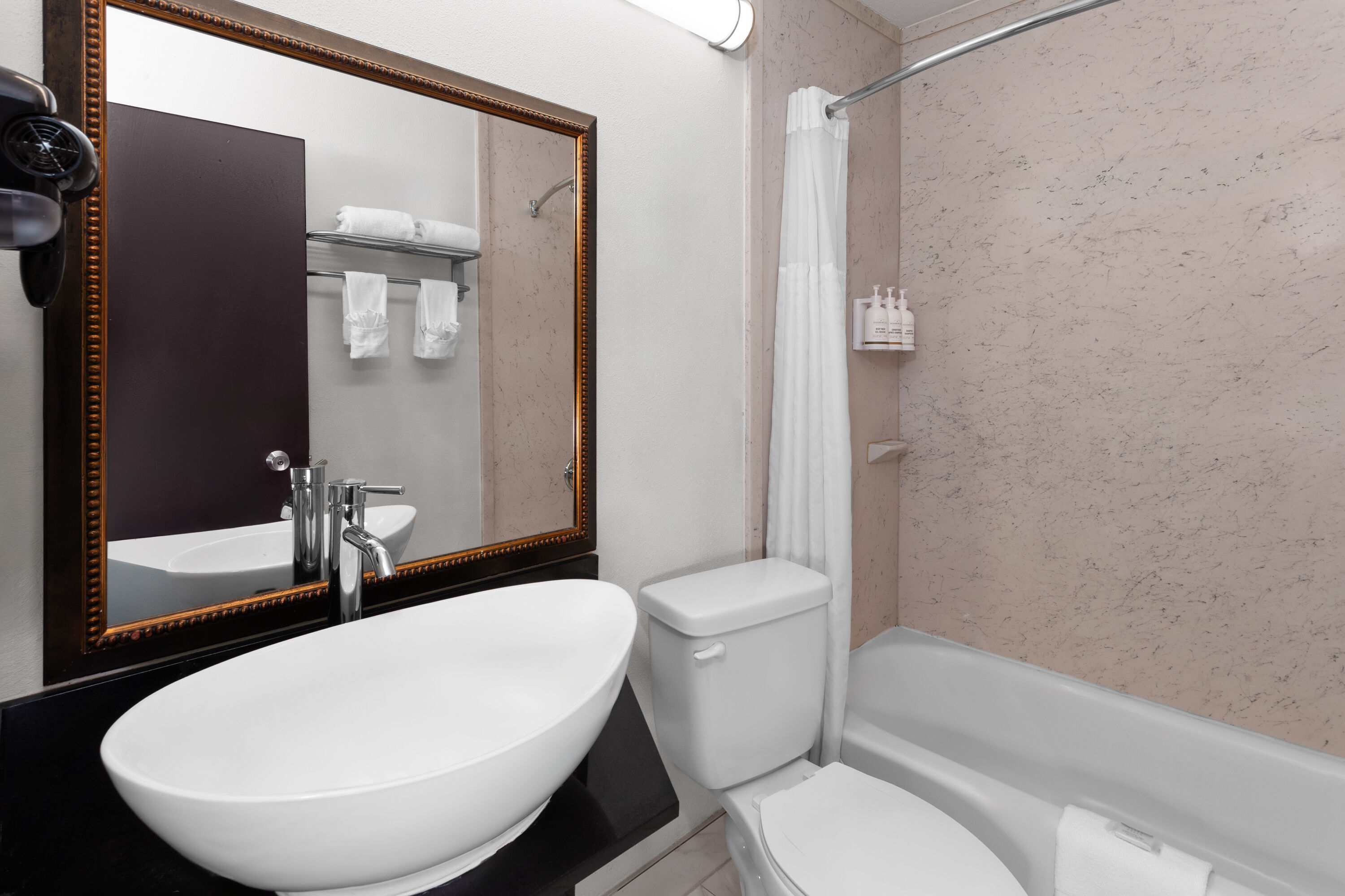 Guest room bath at the Travelodge by Wyndham Milwaukee in Milwaukee, Wisconsin