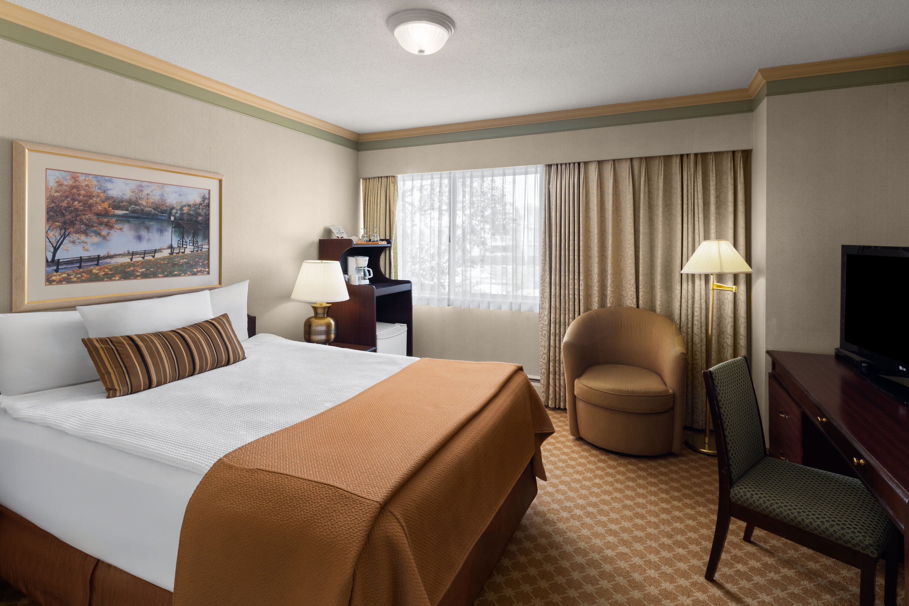 Guest room at the Royal Scot Hotel & Suites, Trademark Collection by Wyndham in Victoria, British Columbia
