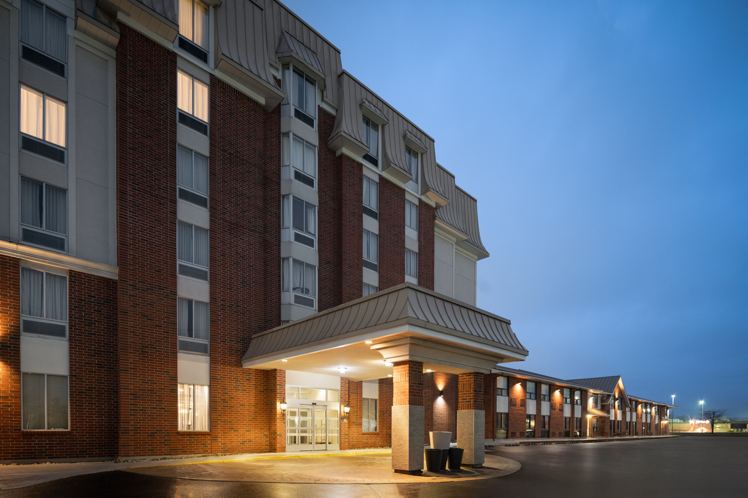 Exterior Dusk Image of Waterloo Suites Hotel, Trademark Collection by Wyndham hotel in Waterloo, Ontario